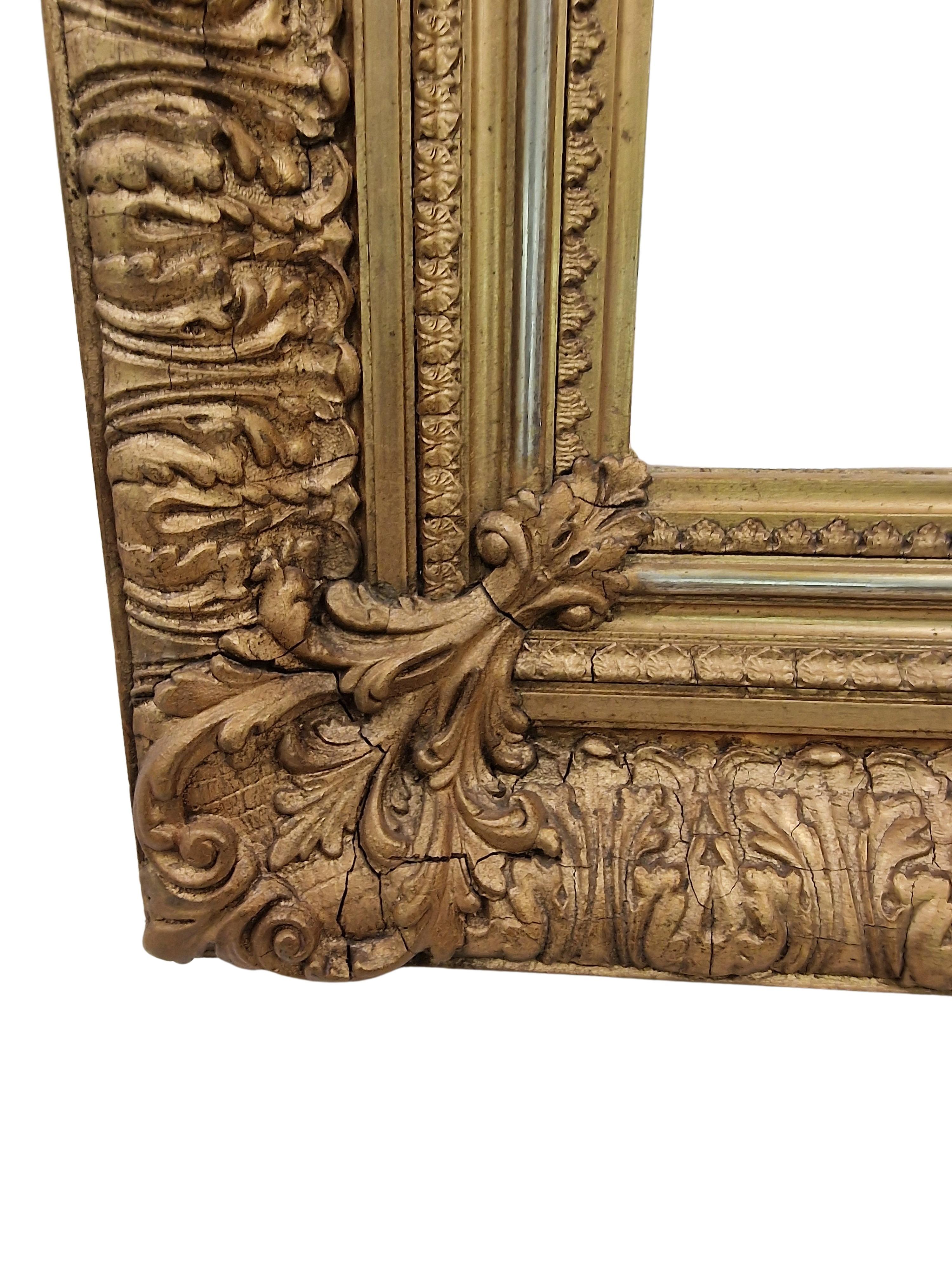 Magnificent wall mirror, frame, an impressive original from the 1880s, made in Austria. 

This impressive hand crafted object is made of wood with a stucco overlay, which is extremely splendidly crafted. There is a gilt metal surface above it,