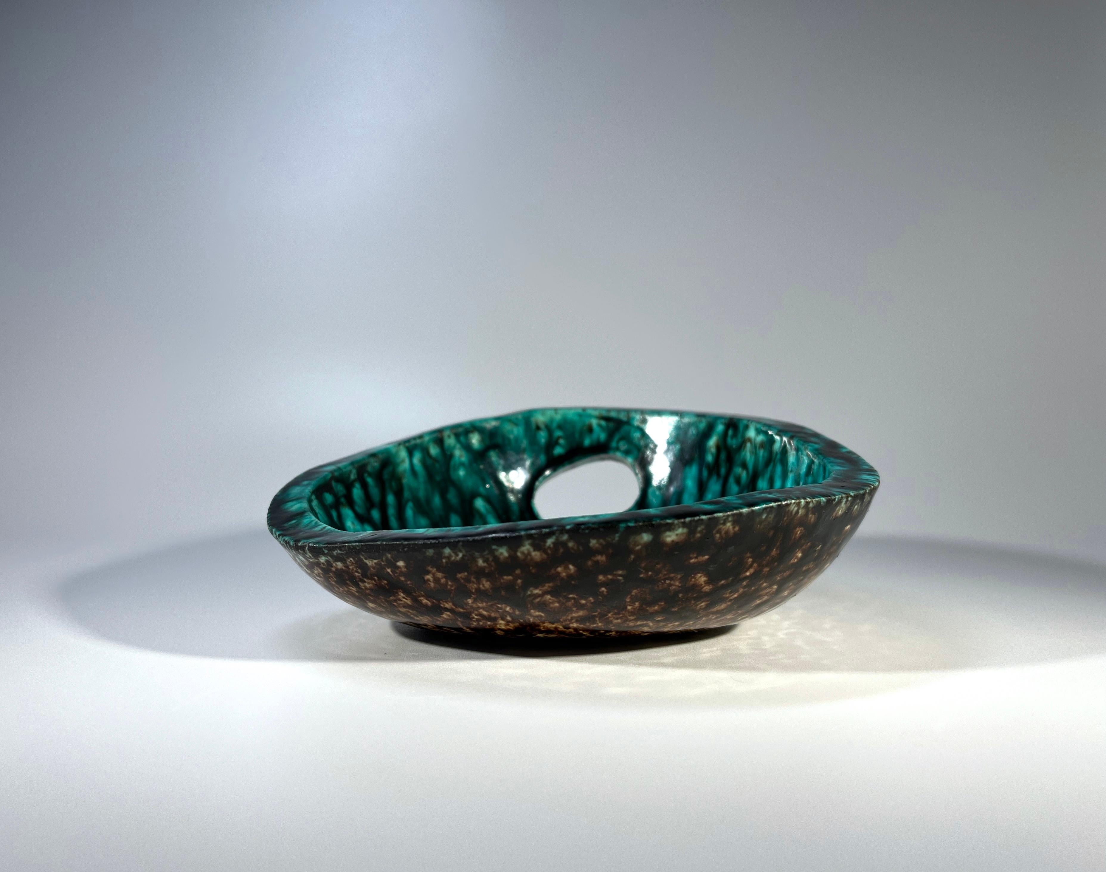 A magnificently vivid, mottled sea green glaze decorates the interior of this free form vide-poche from Accolay, France
The underside also benefits an equally wonderful rich dark brown mottled glaze
A super eye-catching piece from Accolay
Circa