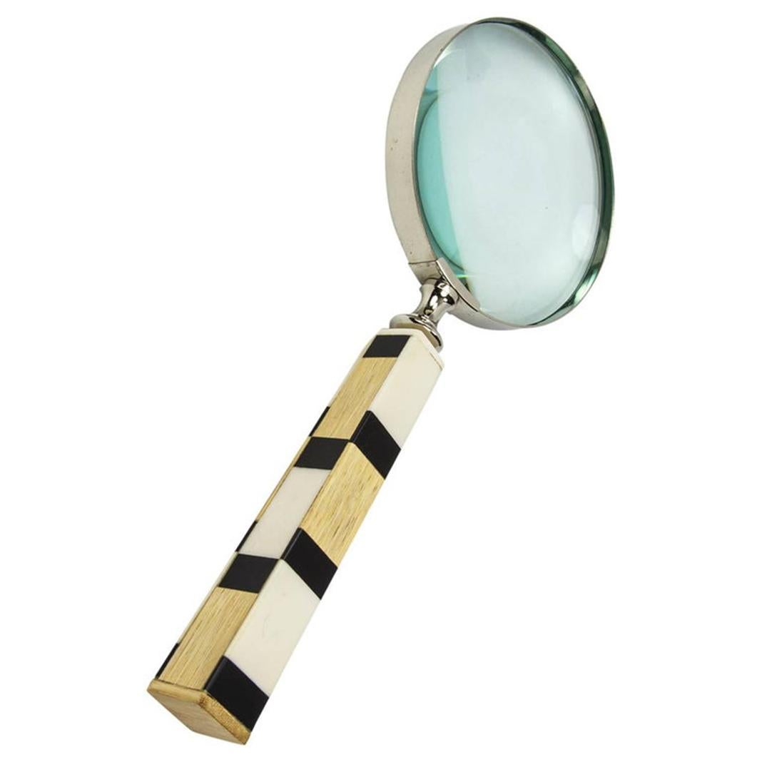 Featuring a magnifying glass with celluloid and wood handle, approximately 10” long, chrome rimmed magnifying glass measures approximately 4” in diameter, modernistic, avant-garde and functional!
 