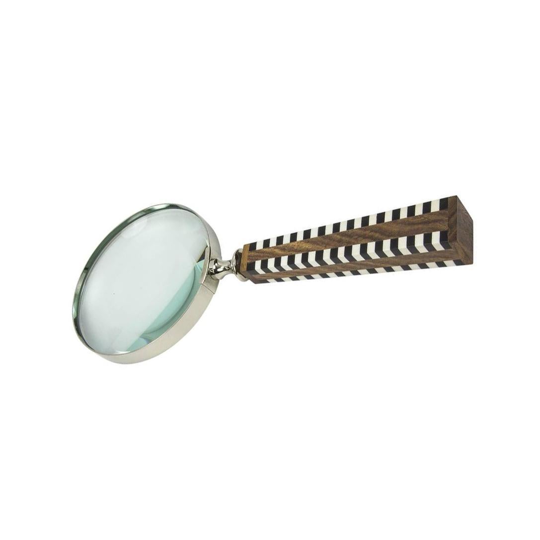 Featuring a celluloid and wood handle magnifier; approximately 10” long; chrome rimmed magnifying glass measures approximately 4” in diameter; modernistic, Avant Garde and functional!
 