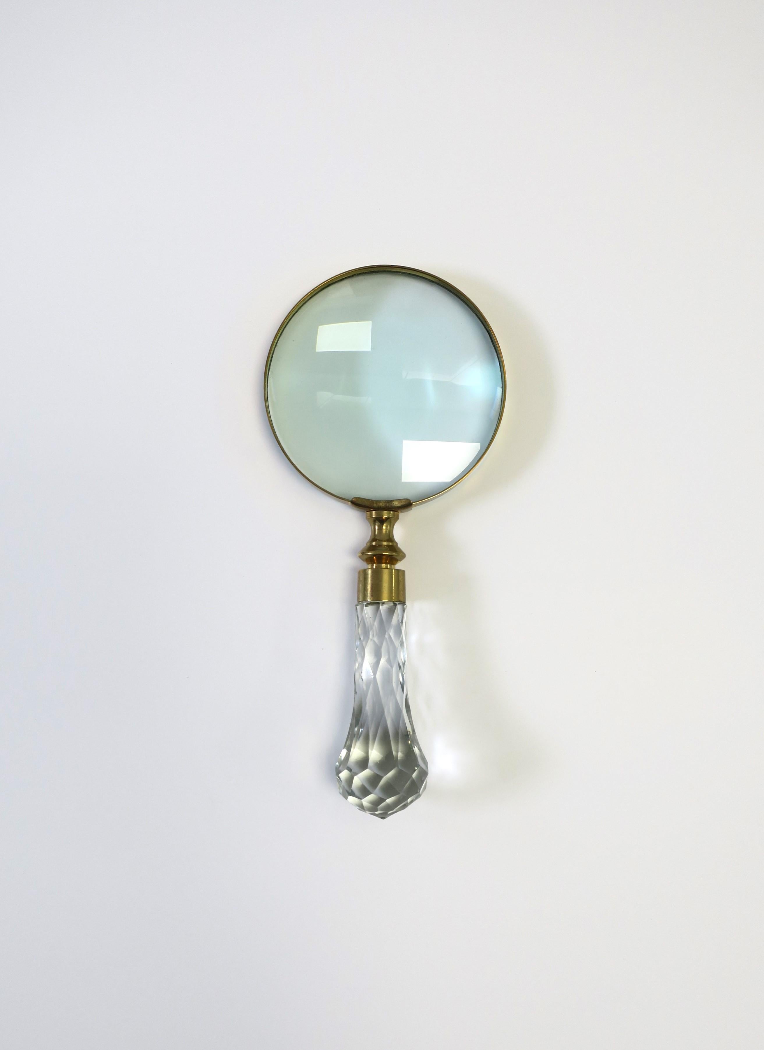 A beautiful and substantial crystal and brass magnifying glass, circa mid to late-20th century. Piece has a beautiful, faceted crystal handle with brass hardware. A great piece for a desk, office, library, etc. Dimensions: 1.5
