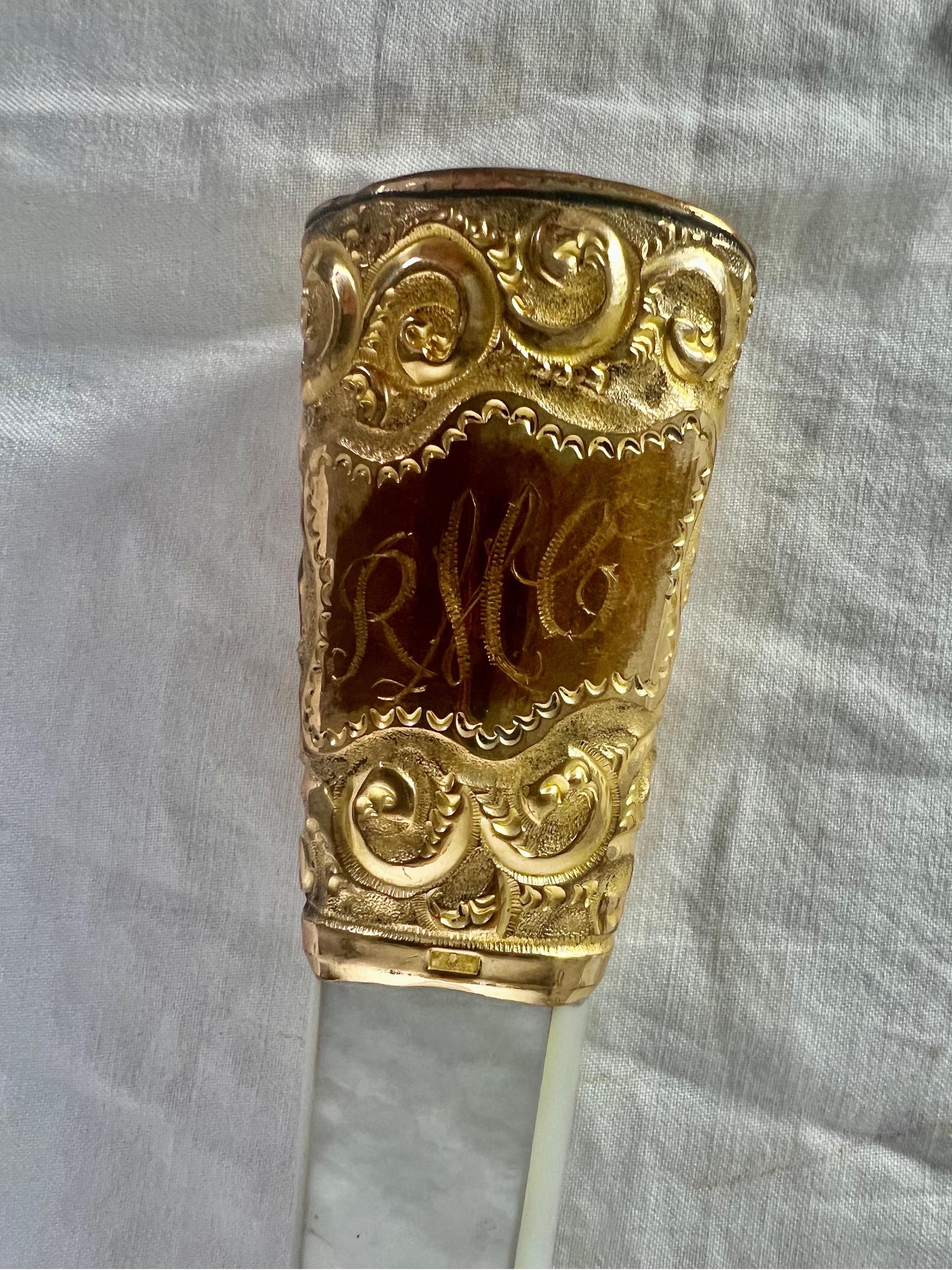 A custom magnifying glass made from a Victorian parasol handle by K&H adorned with intricate mother-of-pearl detailing and gold-washed silver repousse.  The handle is monogramed 