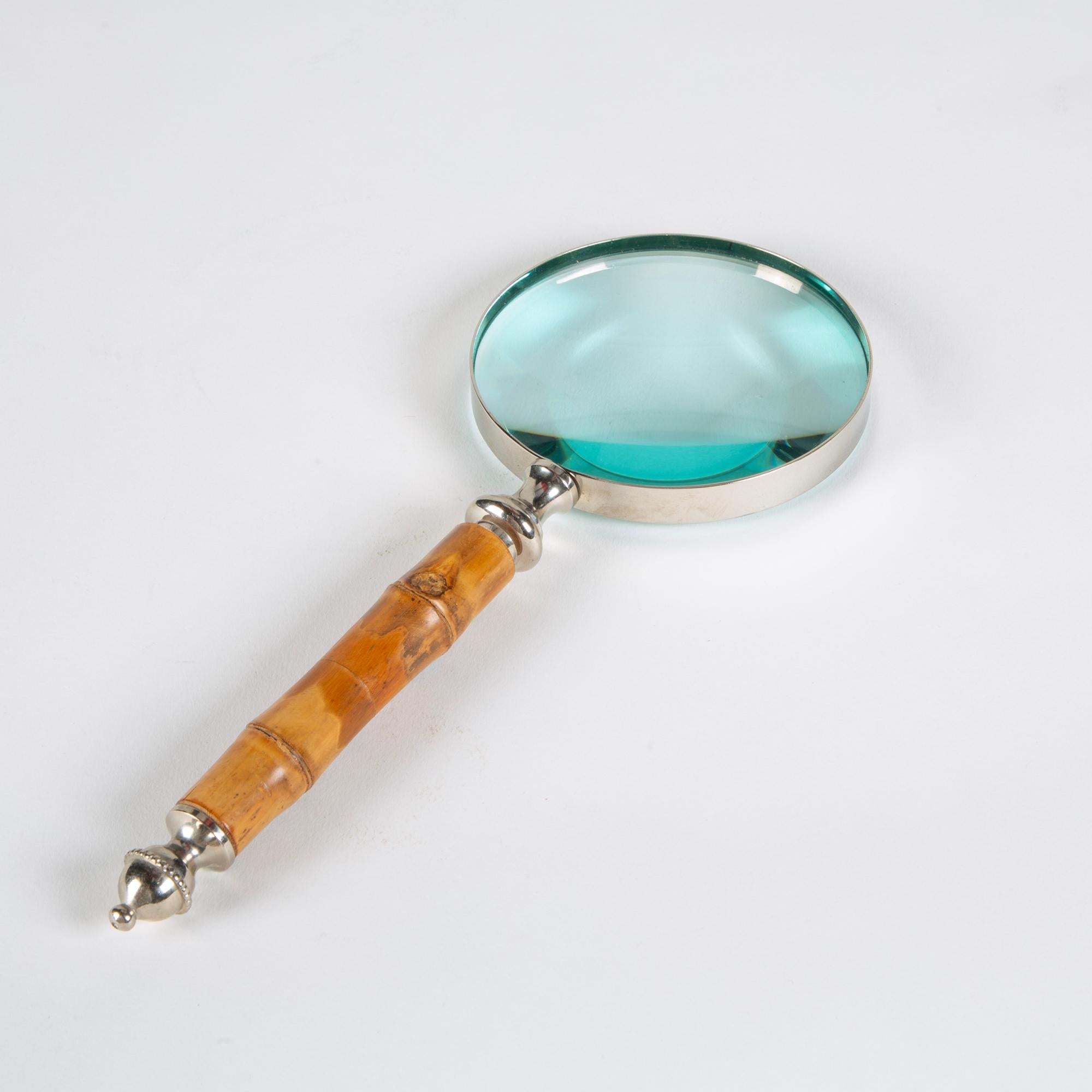 Silver metal frame magnifying glass with a bamboo handle in varying tones of brown. A fun addition to a bookshelf or coffee table décor.

Dimensions: 10.25