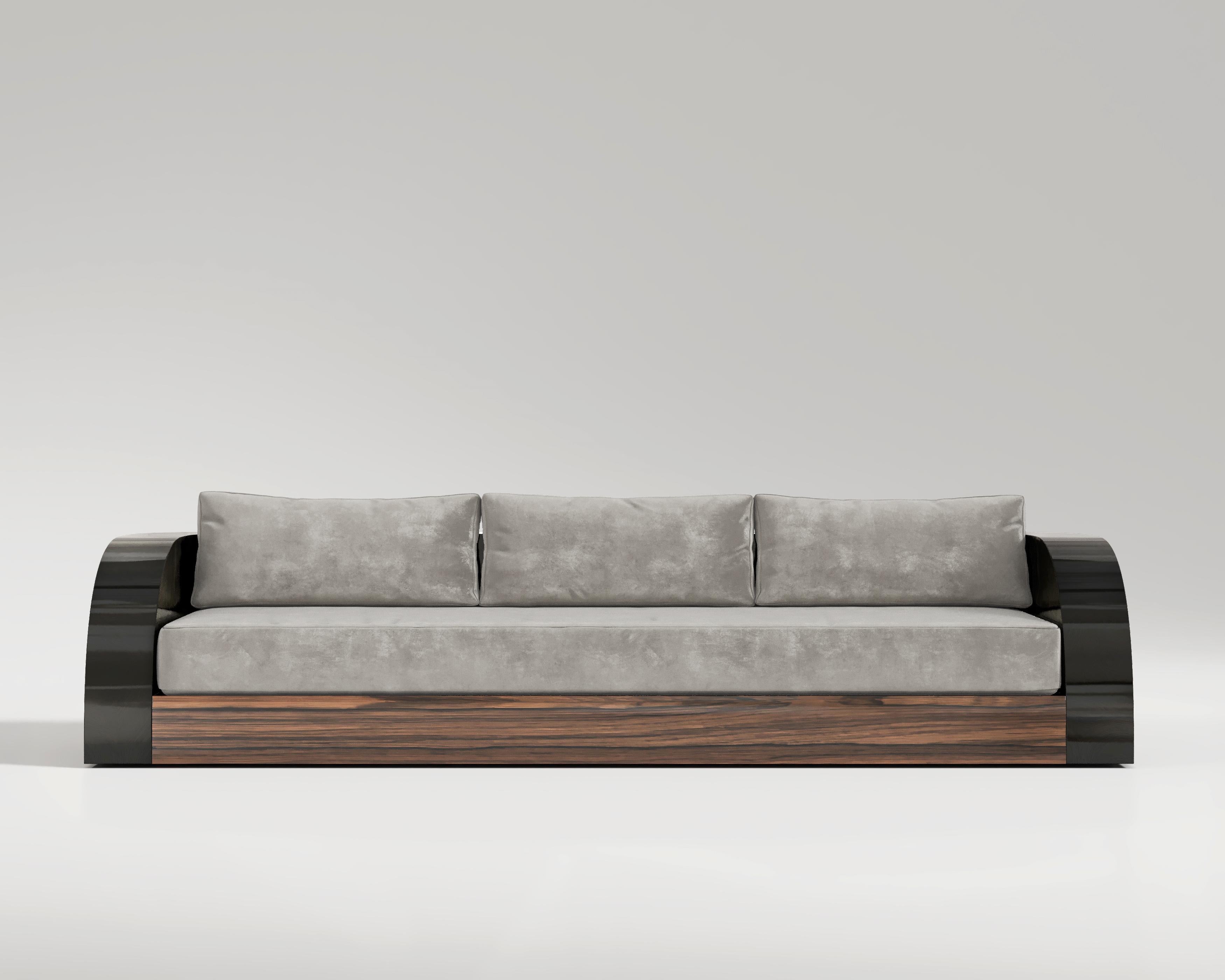Magno  Sofa 

The Magno Sofa is a true work of craftsmanship, meticulously handmade with a black lacquer frame and a walnut base. Its stunning beauty is complemented by beautiful upholstery fabric, and the rounded armrests offer a unique touch of