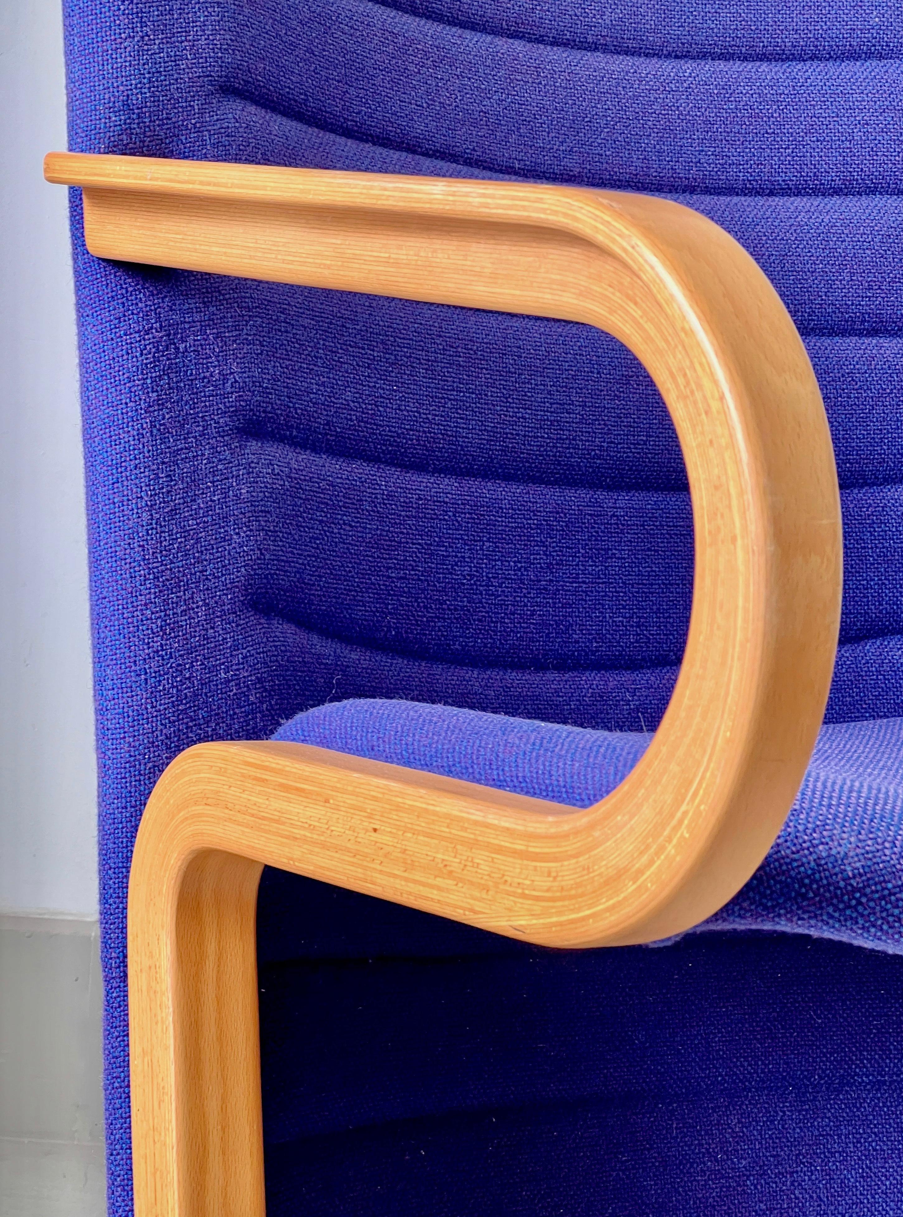Eye-catching blue chair, from Denmark, mid=century  
Attribution mark: Magnus Olesen  
Probably by Rud Thygesen & Johnny Sørensen 
Beautiful wooden curves Original fabric, in a fabulous colour
In very good condition, with minimal signs of age and use