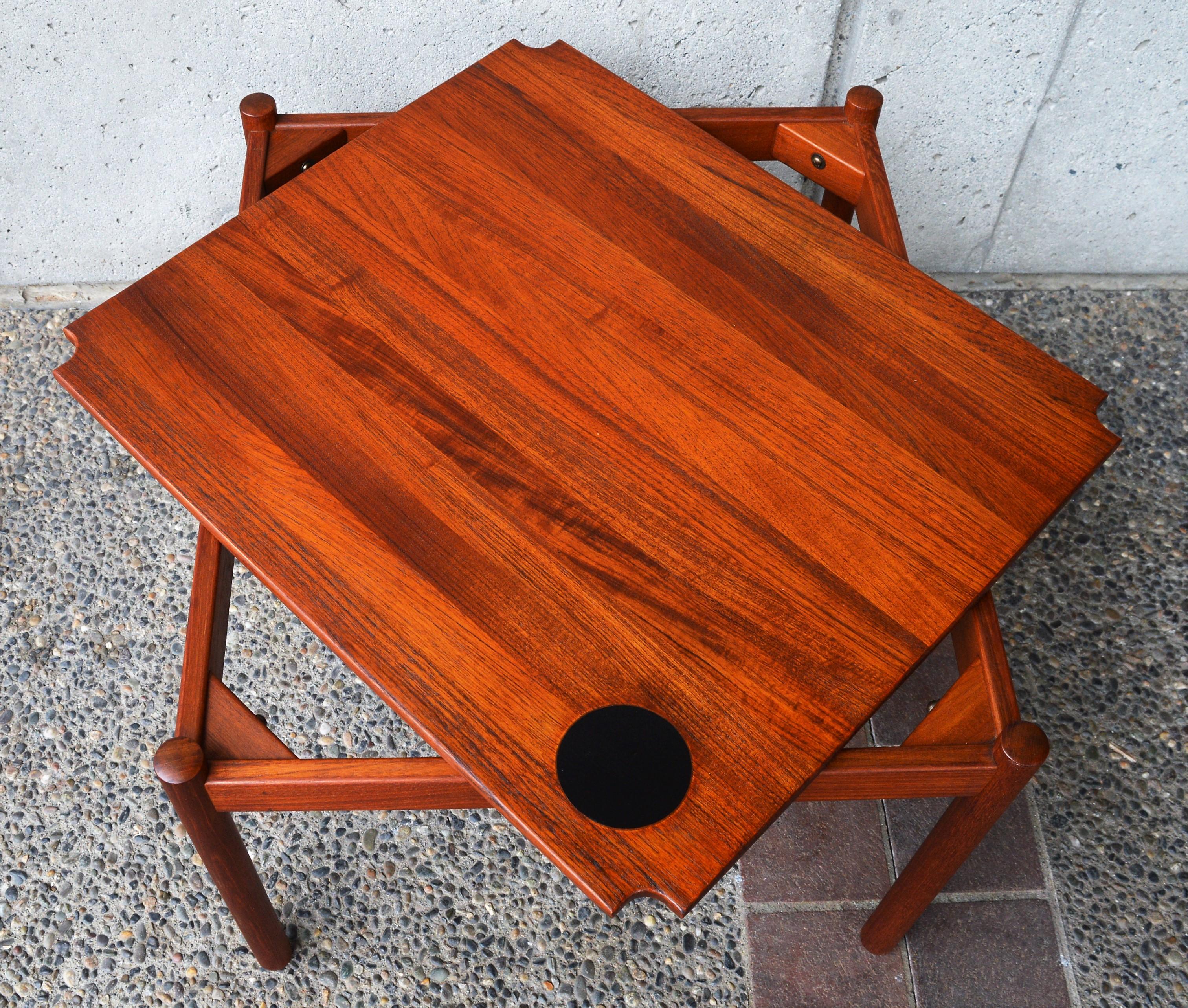 This 1960s Danish modern solid teak coffee table is clever quality table designed by Magnus Olesen for Durup and works both as a side/corner table, or a smaller coffee table. In excellent condition and fully restored, the table has a gorgeous patina
