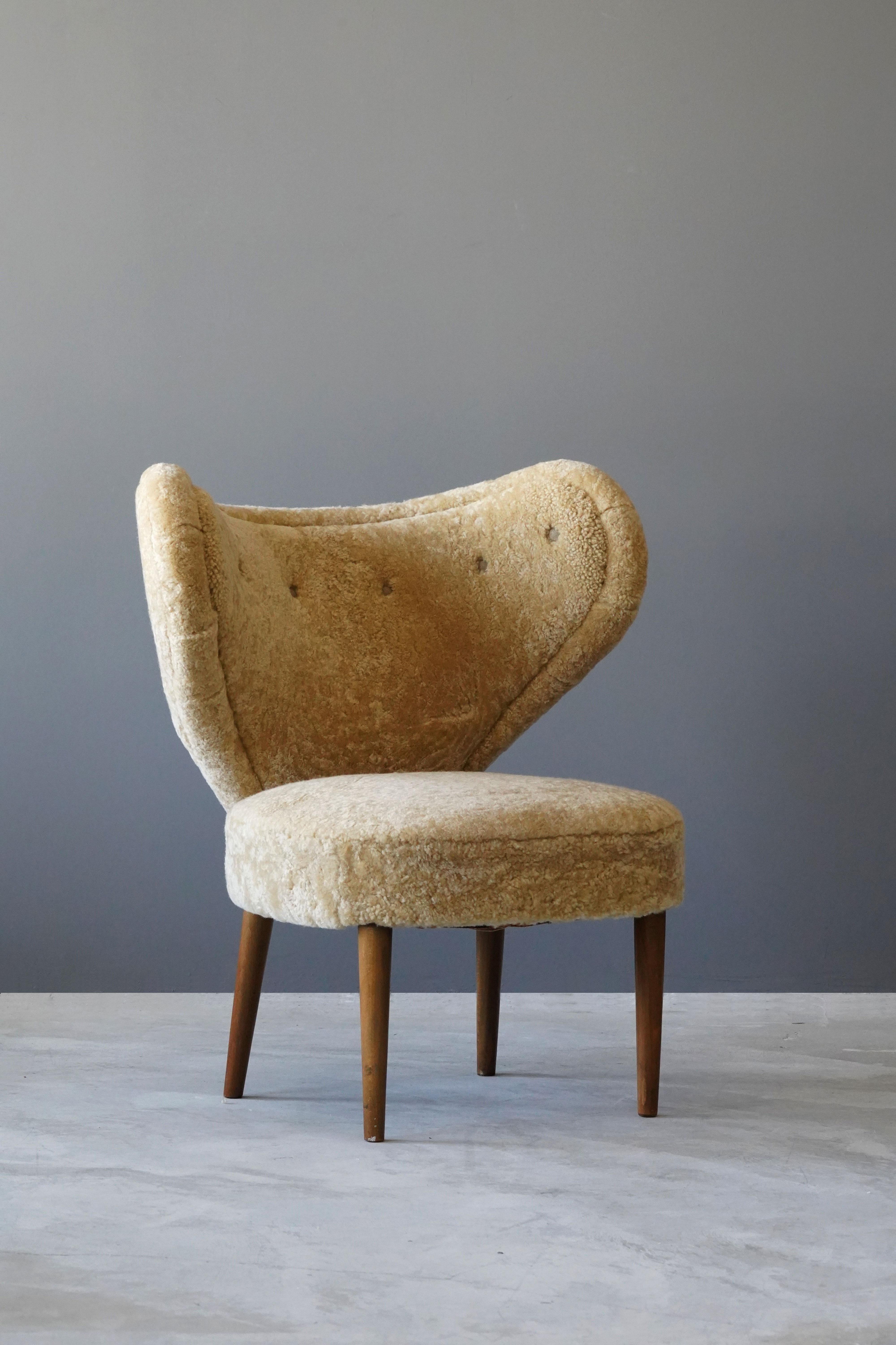 A rare organic lounge chair / high back chair. Design attributed to Magnus Stephensen. The chairs' organic form is further enhanced by sheepskin upholstery. Produced in the late 1940s, or possibly the early 1950s.

Other designers working in similar