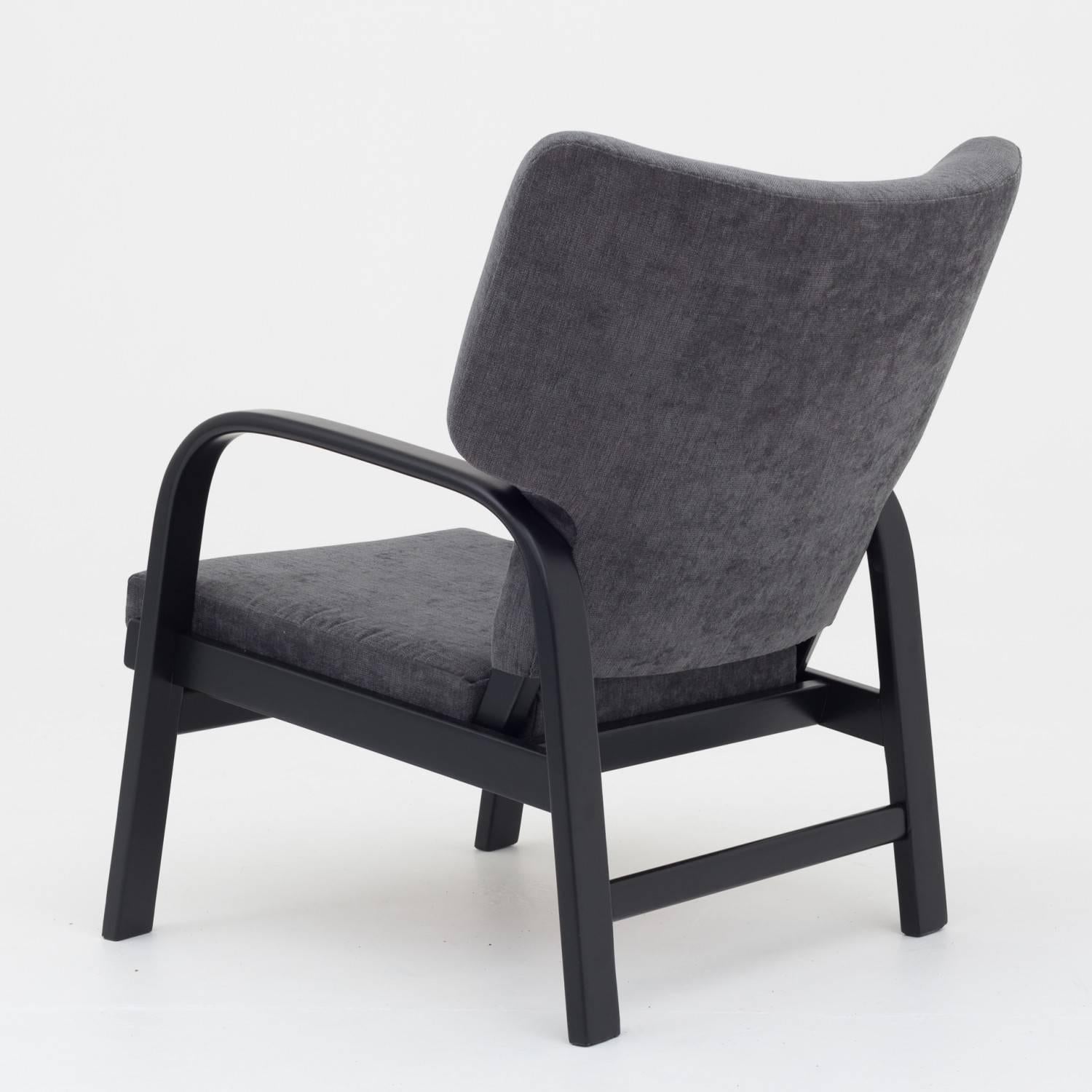 Easy chair black lacquered frame and reupholstered in maple fabric col. 192. Made by Fritz Hansen.