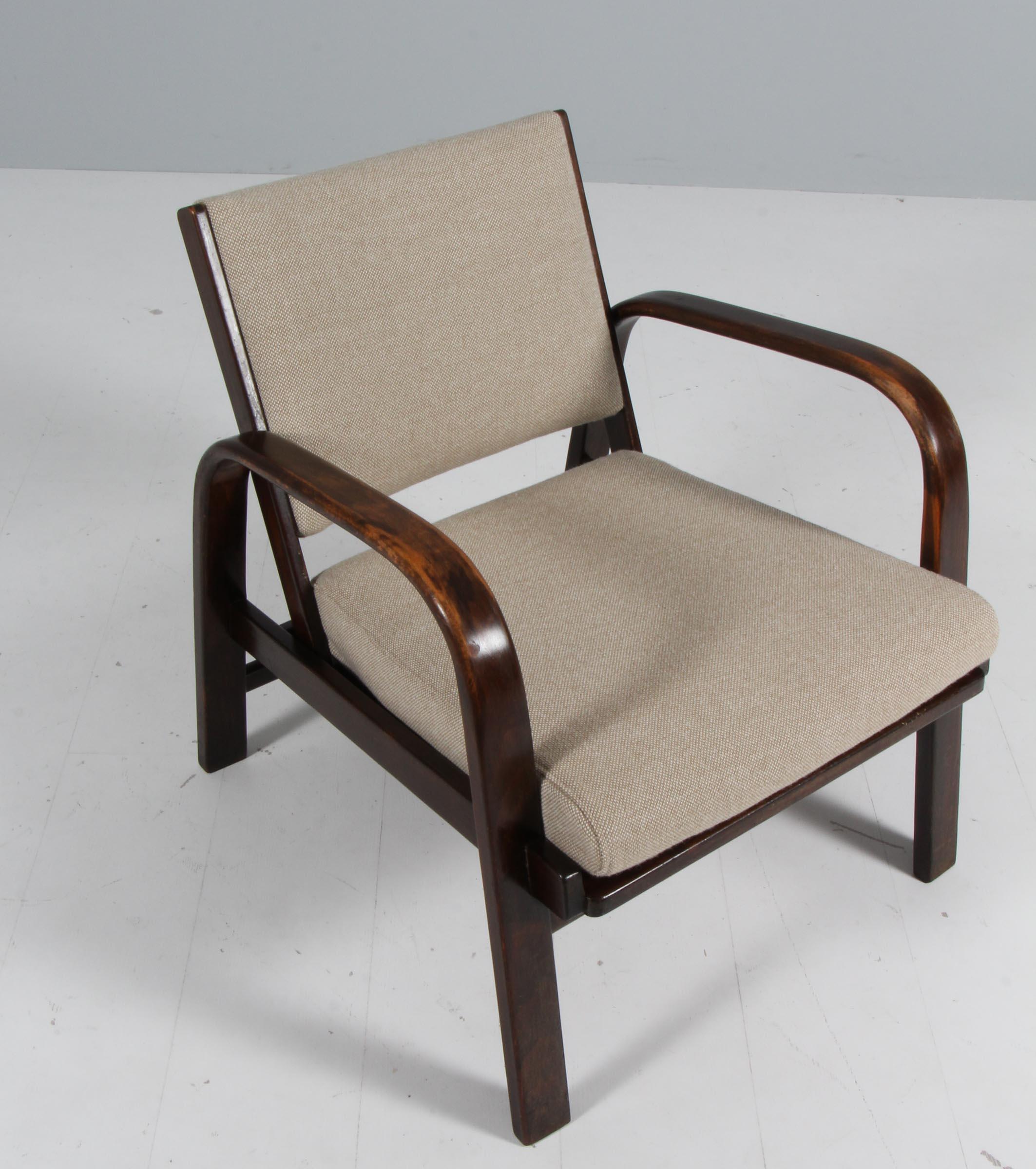 Magnus Stephensen lounge chair with frame of stained beech. New upholstered with Hallingdal Wool. With the original cane in the seat.

Made by Fritz Hansen in the 1930s