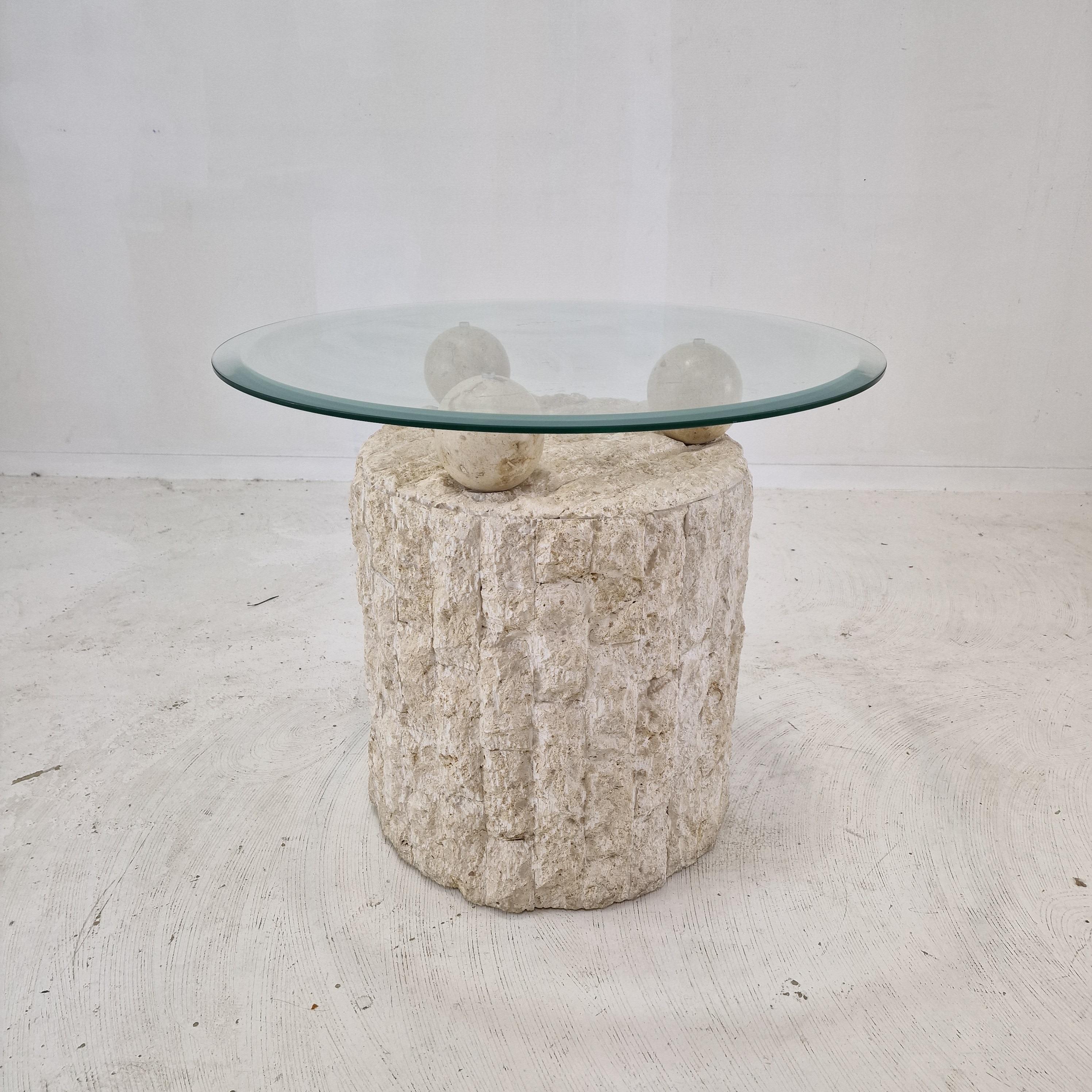 Lovely Postmodern 1980s design, coffee or side table by Magnussen Ponte.

The base of this cute table is made of rough edged brick motif Mactan stone or Fossil Stone. 

Three stone balls holding the removable circular glass plate.
The facet cut