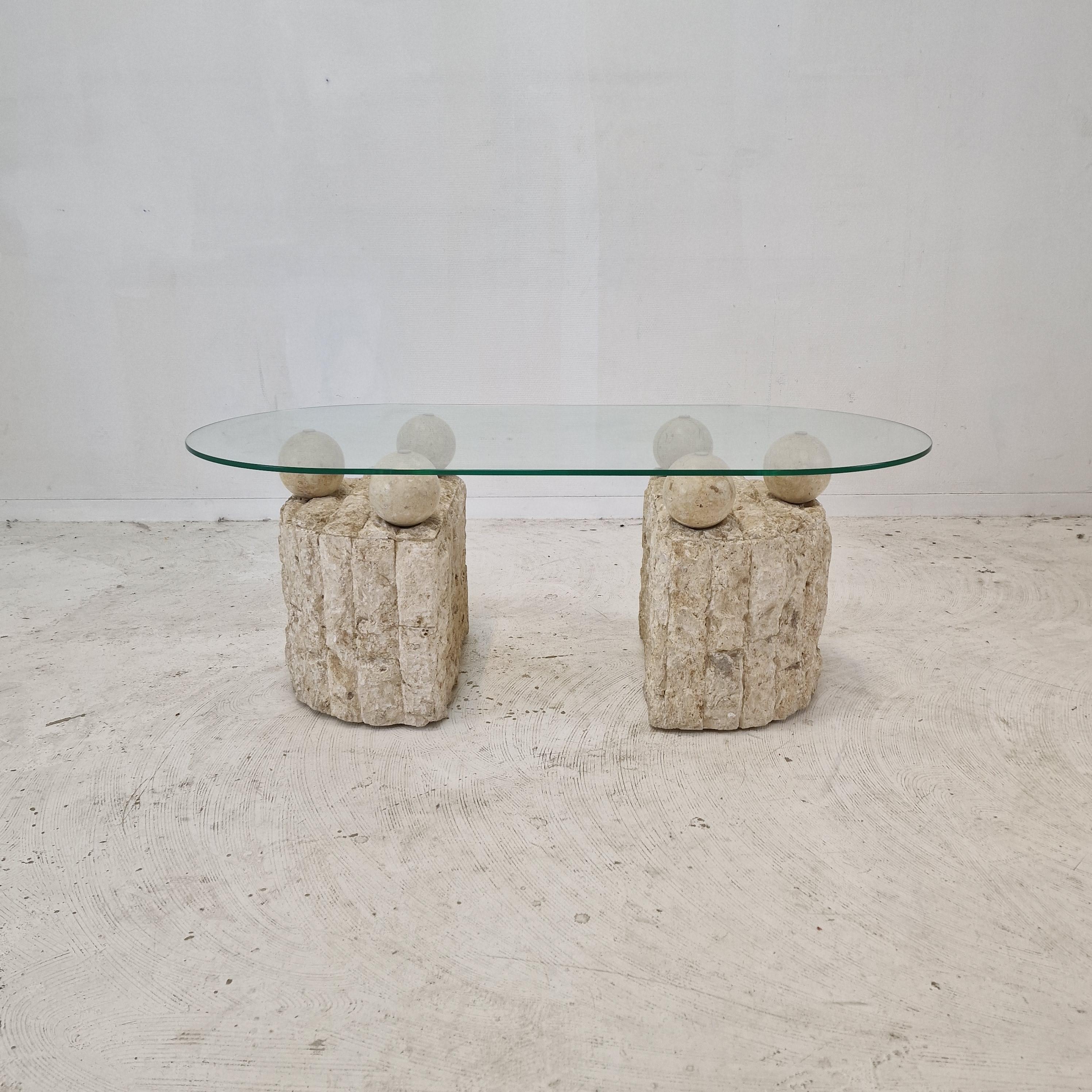 Lovely Postmodern 1980s design, coffee or side table by Magnussen Ponte.

The base of this cute table is made of rough edged brick motif Mactan stone or Fossil Stone. 

Six stone balls holding the removable glass plate.
The table is in very good