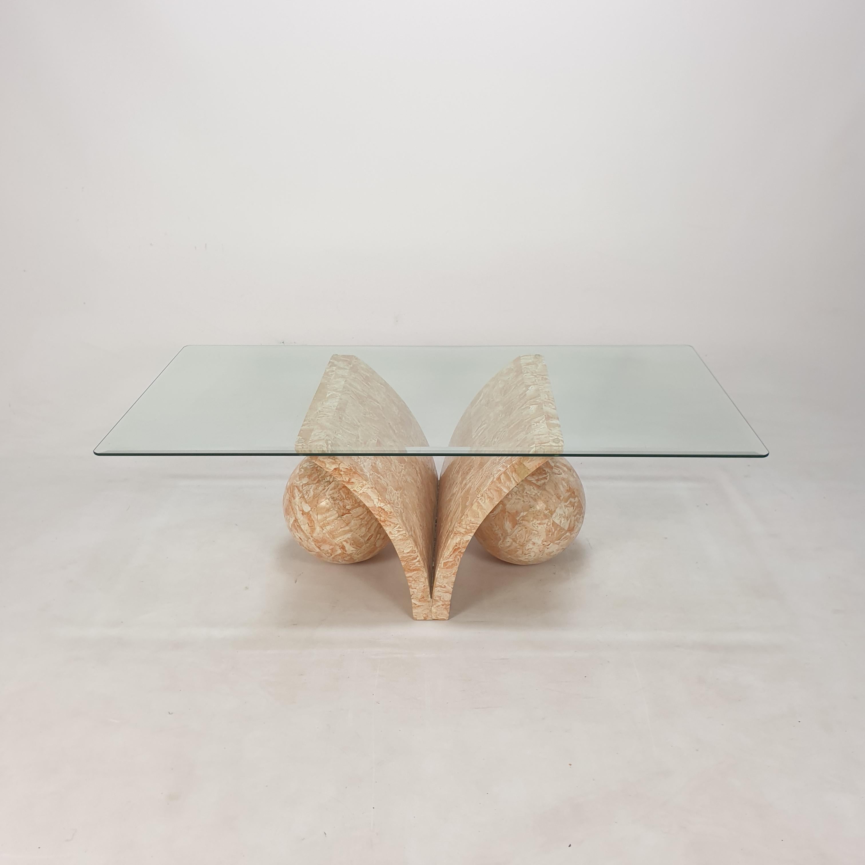 Very rare coffee or side table by Magnussen Ponte, 1980's.

The stunning table base is made of Mactan stone or Fossil Stone.

It has a facetted glass plate.