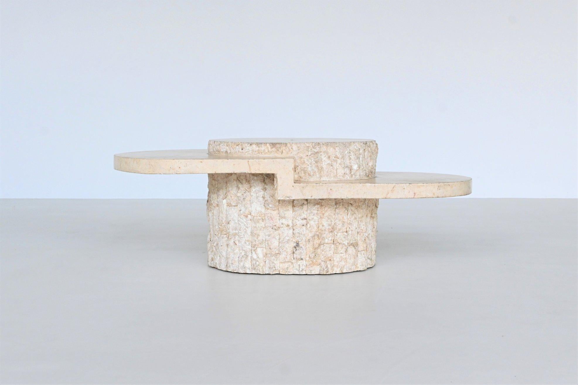 Beautiful sculptural oval coffee table designed and manufactured by Magnussen Ponte, Italy 1970. The top is made of highly polished cream white Mactan stone supported by a signature textured carved stone tile base. This brutalist striking coffee