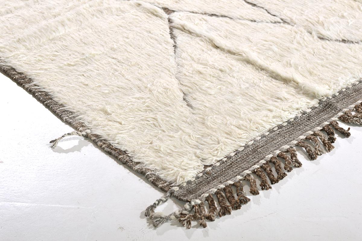 'Mago' is handwoven of luxurious wool, with timeless design elements. This Mehraban design is a contemporary interpretation of an Azilal, a part of our Atlas collection designed in LA. The perfect shade of white and embossed detailing. Azilal tribal