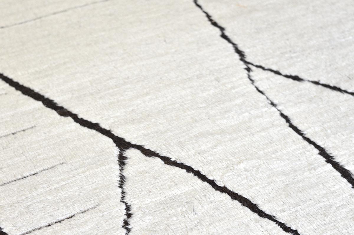 Handwoven white shag rug natural black design motifs inspired by Moroccan Azilals recreated for the modern design world. Mago can withstand high amounts of traffic, crafted to be lived on. Designed in Los Angeles.



Rug Number 27751
Size 11'