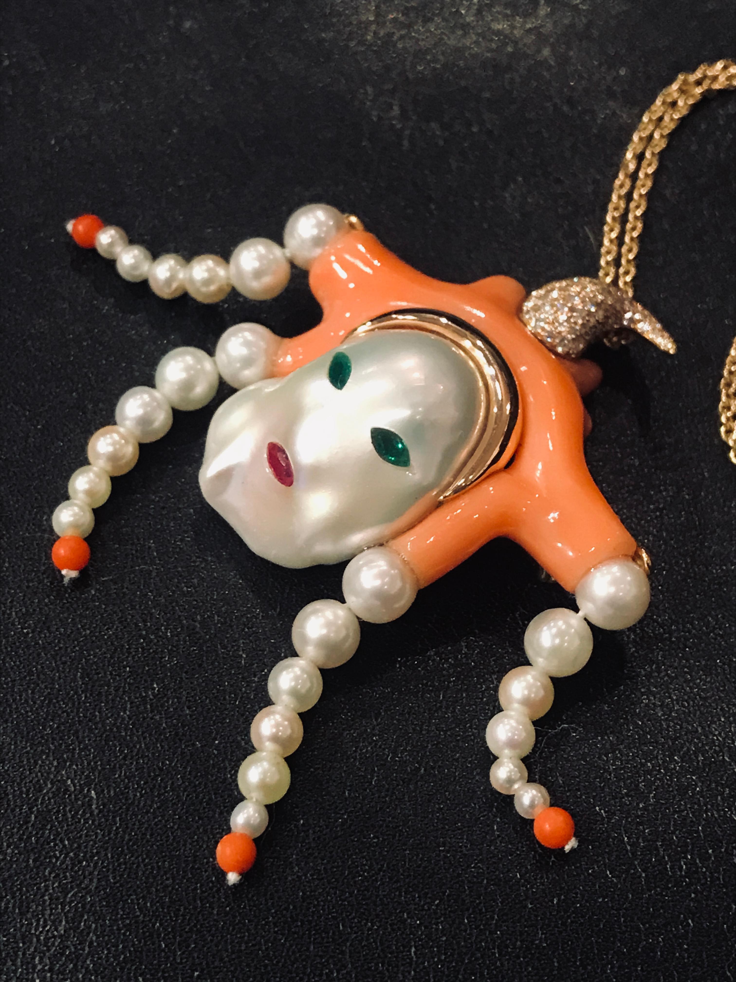 A one of a kind rose gold, natural pinkish-orange Mediterranean coral (Rubrum), diamonds ( 0,63 Cts), pearls, emeralds and ruby convertible brooch-pendant. 
This unique piece is called “Magot”, as a tribute to the occidental taste for “Chinoiserie”