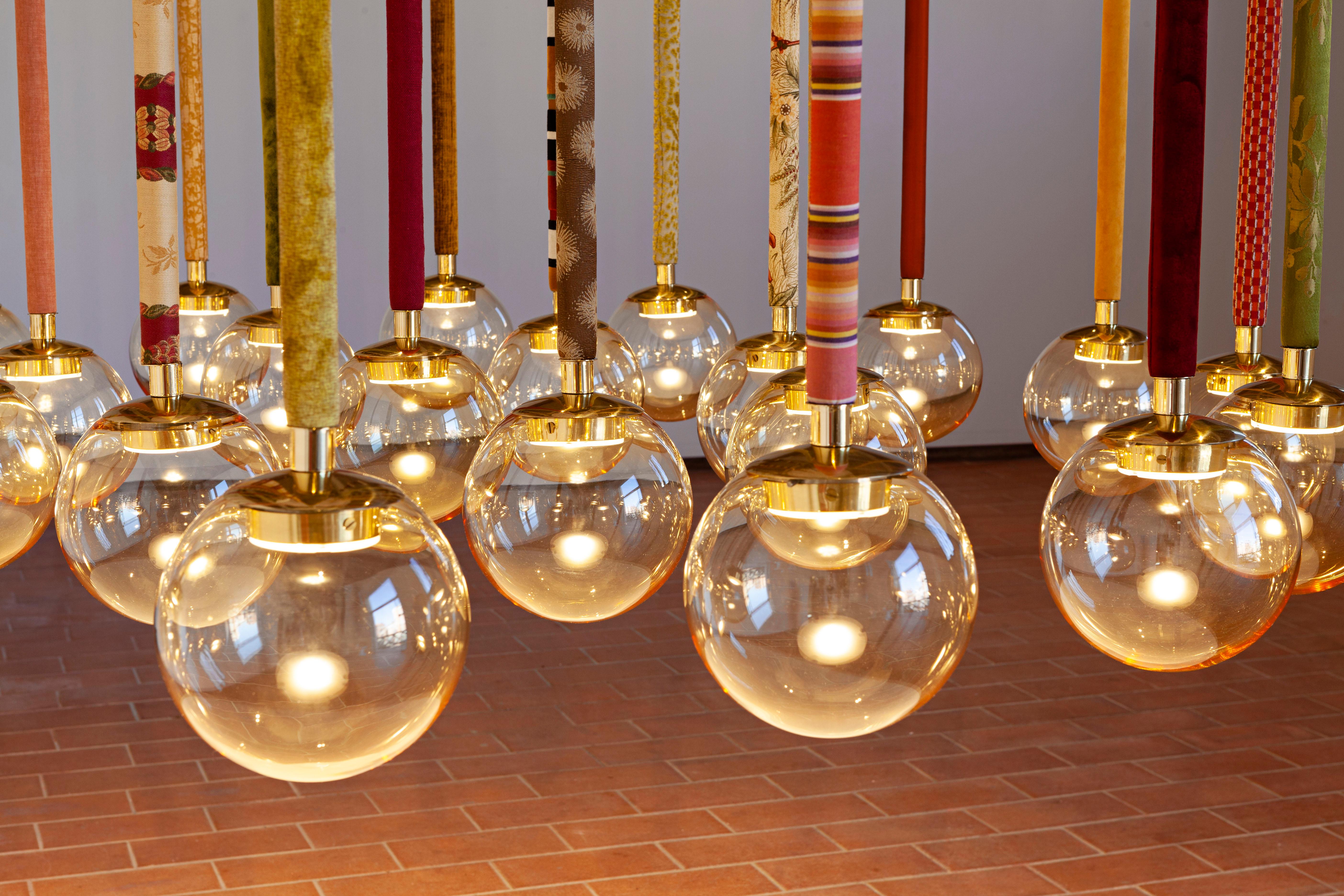 21st Century Filippo Feroldi Suspension 13 lamps Murano Glass and Brass Various Colors.
Designed by Filippo Feroldi for Purho and Colleoni Arte, Magus 13 is a chandelier composed of thirteen Murano blown glass spheres of 18 cm each — available in