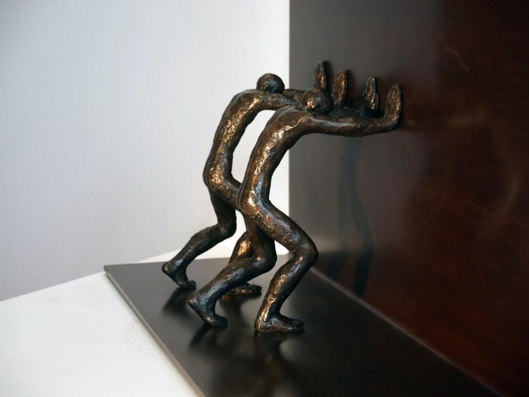La Force II is a sculpture by the French contemporary artist, Maguy Banq.
Figures are in bronze and wall is iron with patina 
Edition 3/8.

The existentialism is in the center of Maguy Banq approach: the human being is predestined for nothing, he
