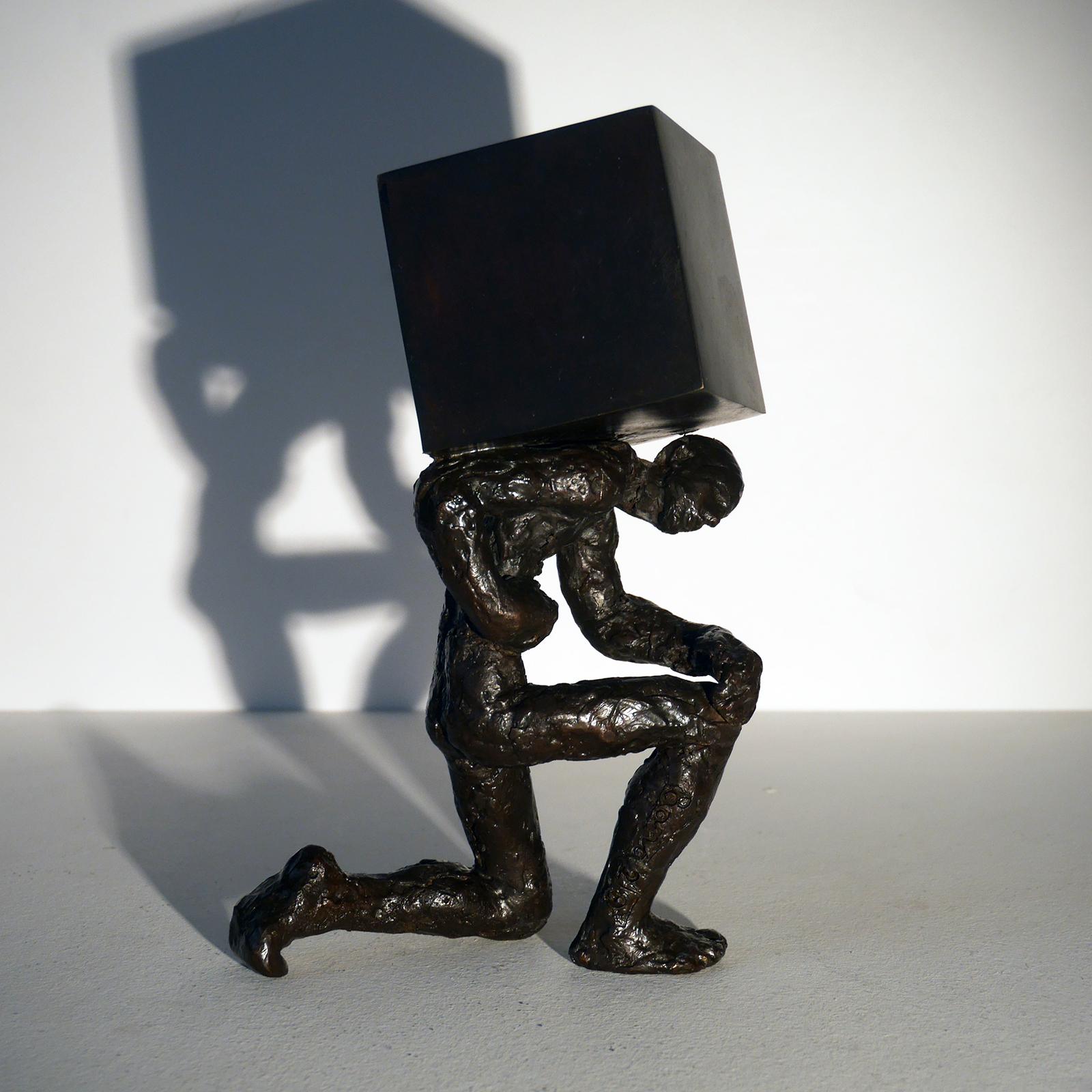 Le porteur de pierre bronze figurative sculpture, man holding a stone by M. Banq - Sculpture by Maguy Banq