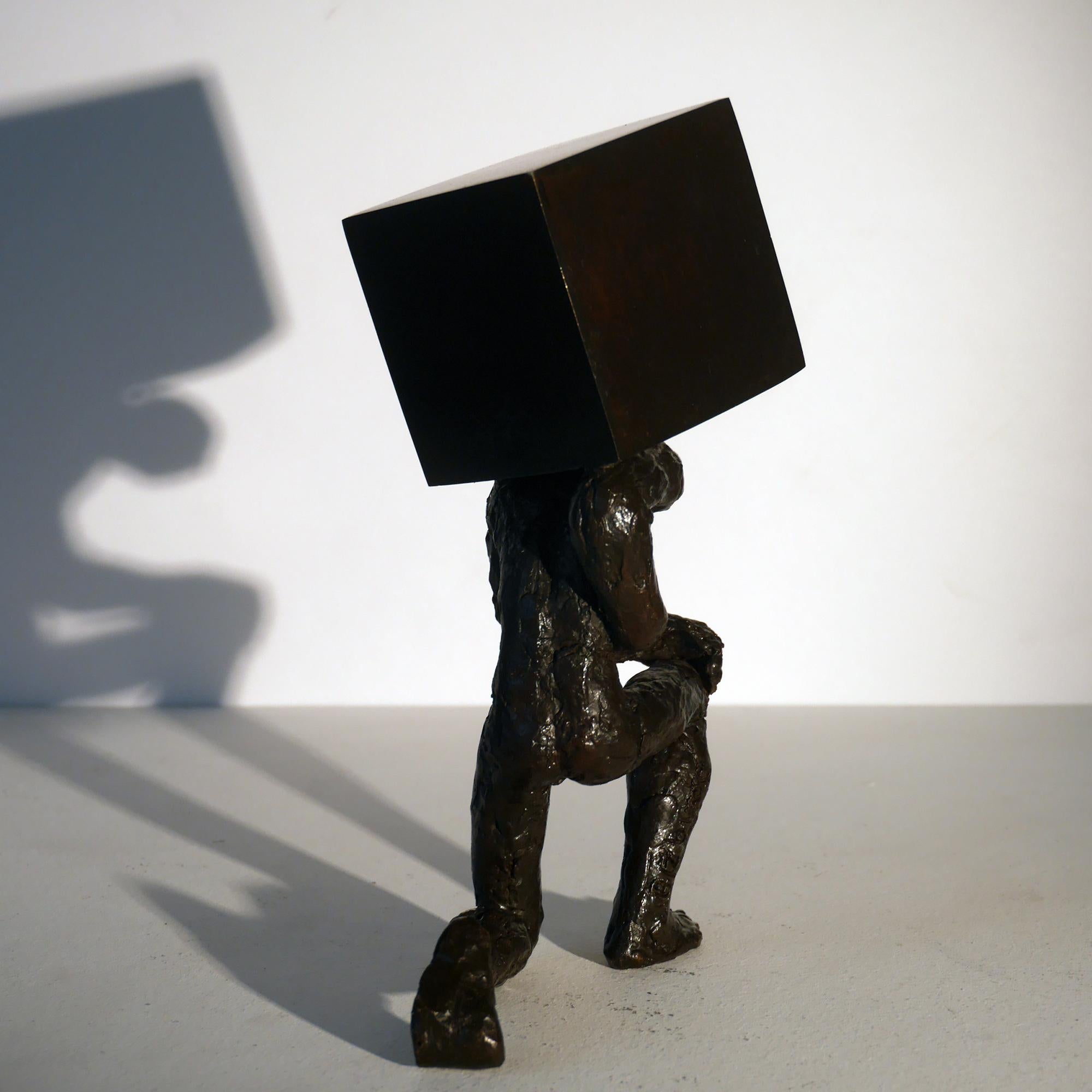Le porteur de pierre bronze figurative sculpture, man holding a stone by M. Banq - Contemporary Sculpture by Maguy Banq