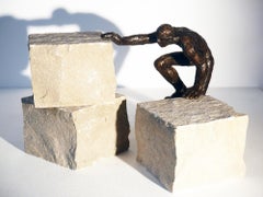 L'escalade, figurative bronze, man climbing, installation with stones by M. Banq