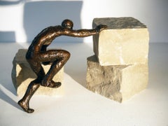 L'escalade, figurative bronze, man climbing, installation with stones by M. Banq