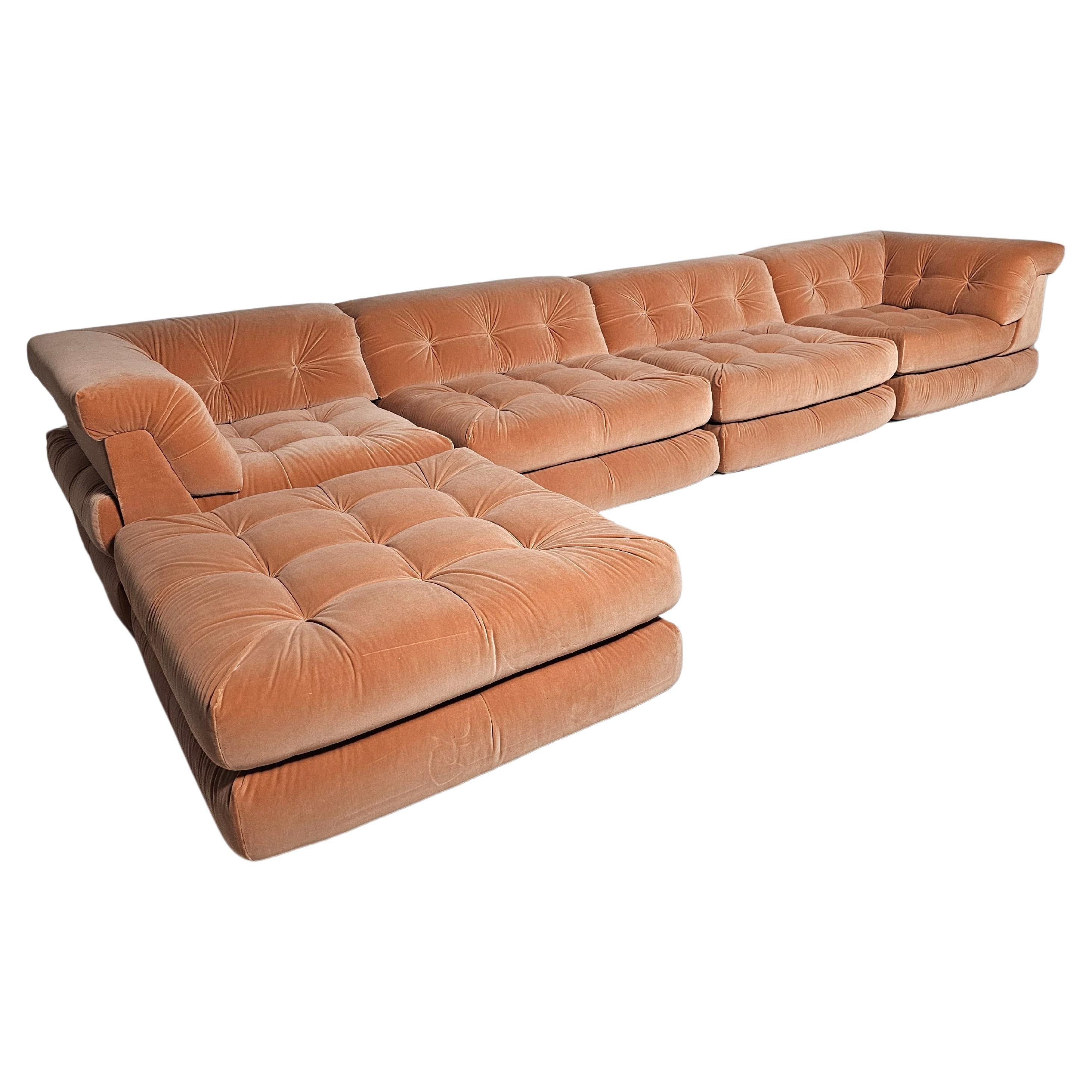 Roche Bobois Mah Jong sofa,  peach pink cotton velvet. 

1st edition reupholstered Mah Jong modular sofa set by Hans Hopfer, designed in 1971 for Roche Bobois. It features multiple cushions that can be arranged in an endless number of ways, This set