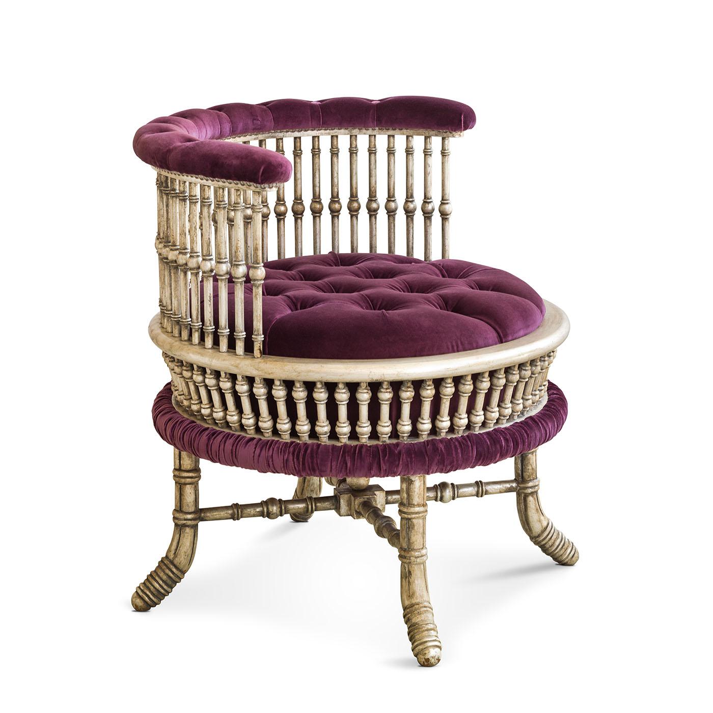 The Mahalia armchair's round shape is adorn by cotton velvet upholstery and exquisite capitonnè detailing. This armchair exudes timeless elegance, combining supreme comfort with a captivating design that adds a touch of sophistication to any