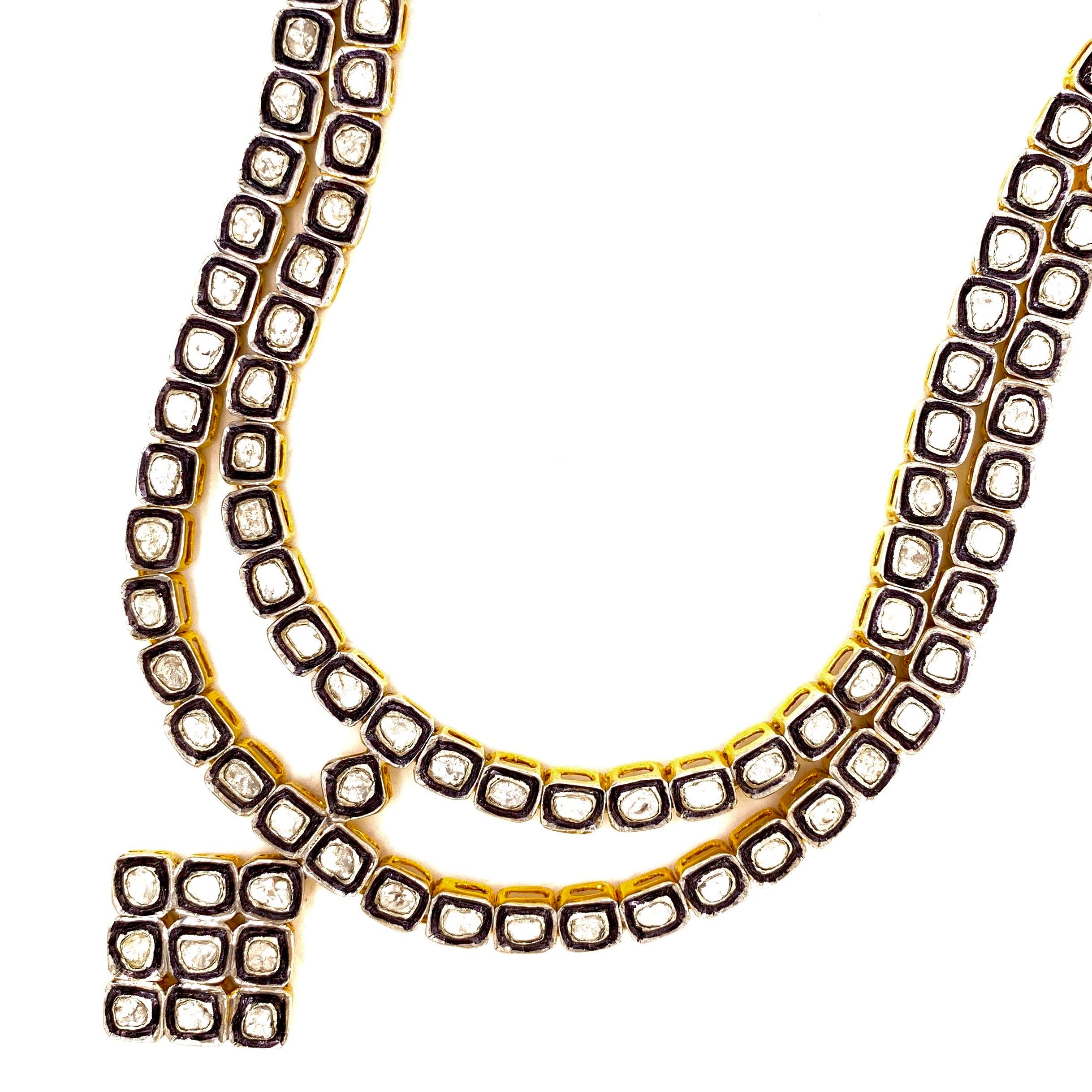 Mughal inspired diamond necklace. Handcrafted, 2 rows of fancy tabular cut 17 carats diamonds mounted in bezel setting, with dangling pendant, accented with oxidized contrast.  Elegant design is set in silver with 18 karat yellow gold plating, along