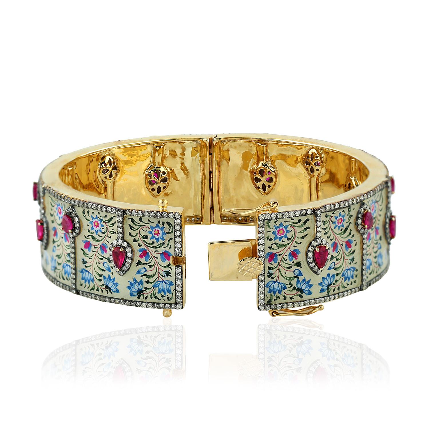 The pieces in Maharaja collection features unique hand painted miniature art set with 18K gold, sterling silver & 4.18 carats diamonds.  This beautiful bangle is filled with bright 2.45 carats of rubies that contrast the enamel art. Clasp