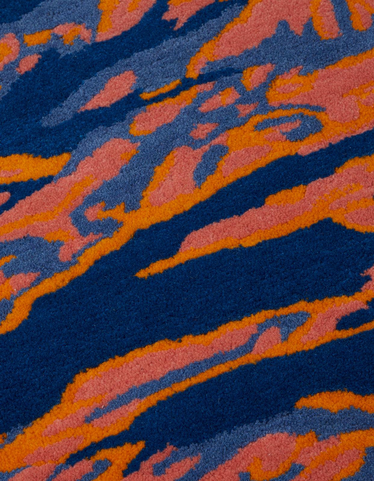 DPM: Pop Tigerskins Series 3. 

Maharishi and The Andy Warhol Foundation continue their ongoing series of collaborative works with this wool rug. 

Based on Andy's 1986 camouflage works, his vivid pop colours have been reworked in DPM: