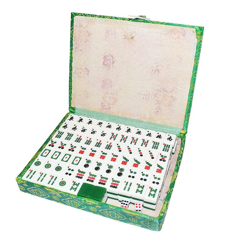 Beautiful vintage Chinese Mahjong set in a green brocade carrying case. A great way to keep family and friends occupied! This set is held in a green satin box. The box itself is covered in a padded silky green fabric with gold stitched details. The