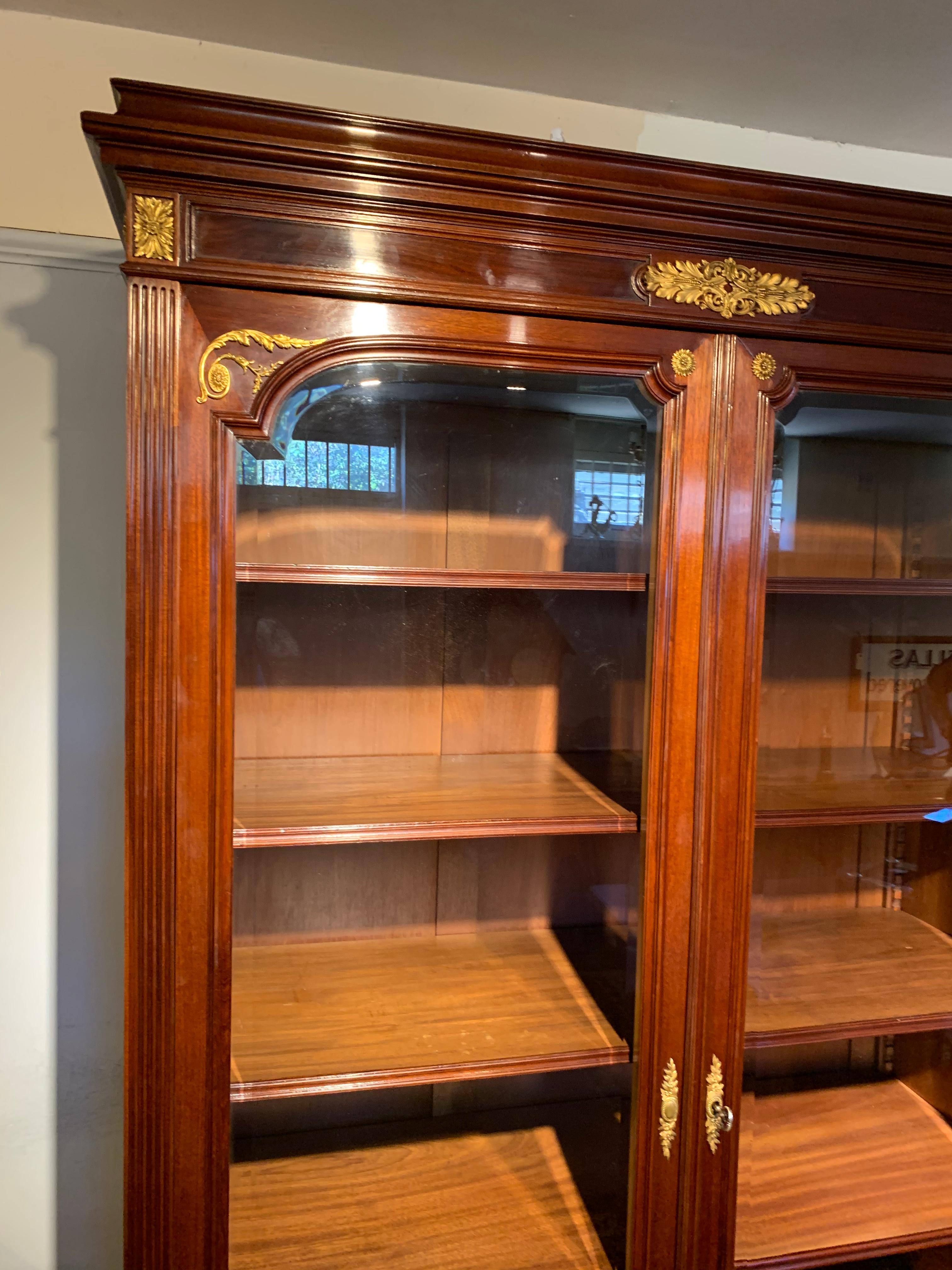 Fabulous 19th century mahogany 2 door bookcase, it is very capacious and will take a lot of large reference books / files

French circa 1870s the 2 large doors opening to reveal 5 fully adjustable shelves, single drawer to the base Having original