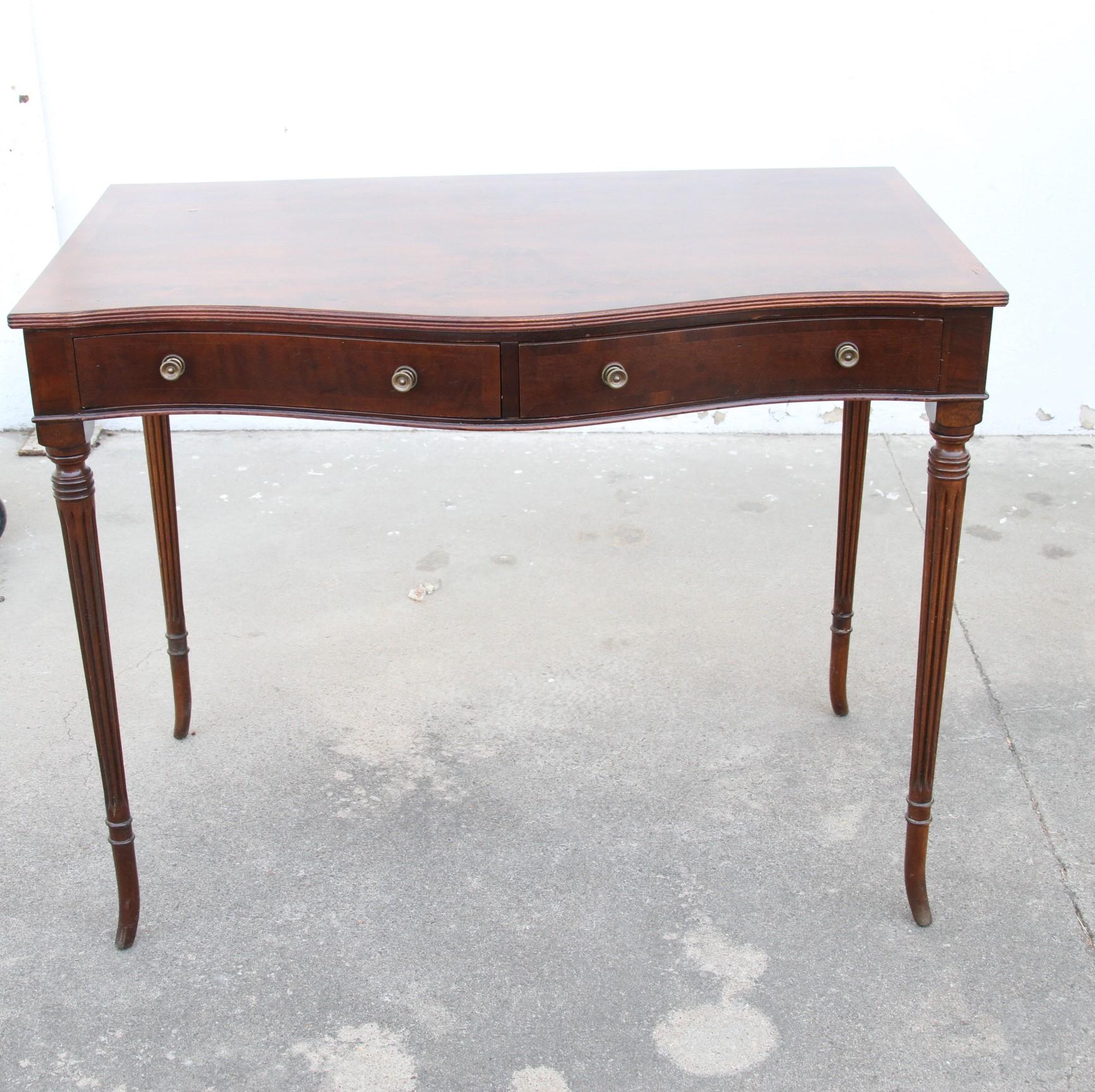 Antique English walnut 2-drawer Writing Table. Item features solid wood construction, beautiful wood grain, distressed finish, 2 drawers, fluted legs, and a burl wood top. A very nice antique item.
Dimensions:

Height: 29