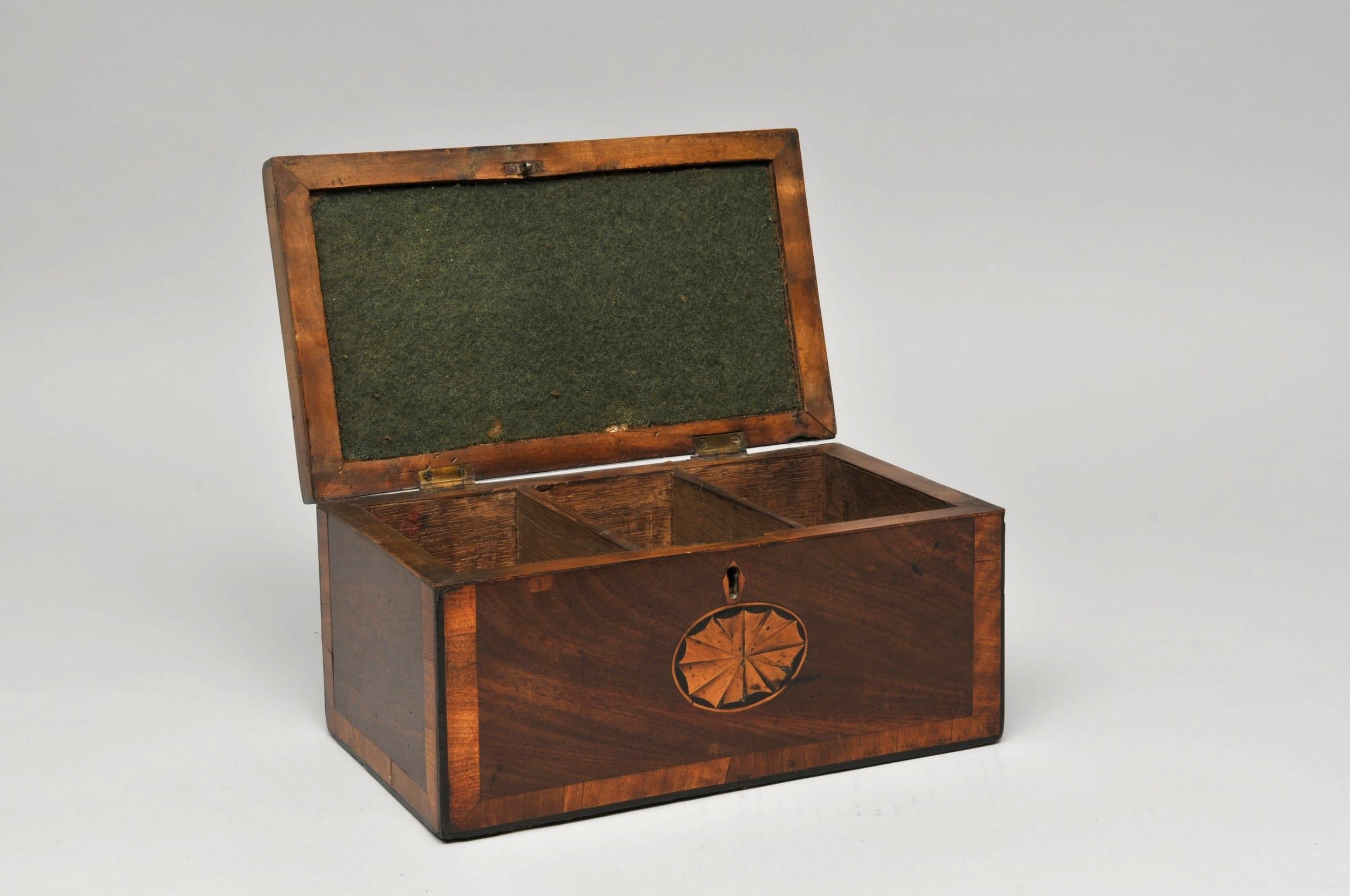 Period tea caddy

Measures: Height 13cm, width 27cm

A beautiful period tea caddy with cross banding and star inlay.

Although wooden tea caddies were made early in the 18th century, it is not until the second half of the century that they