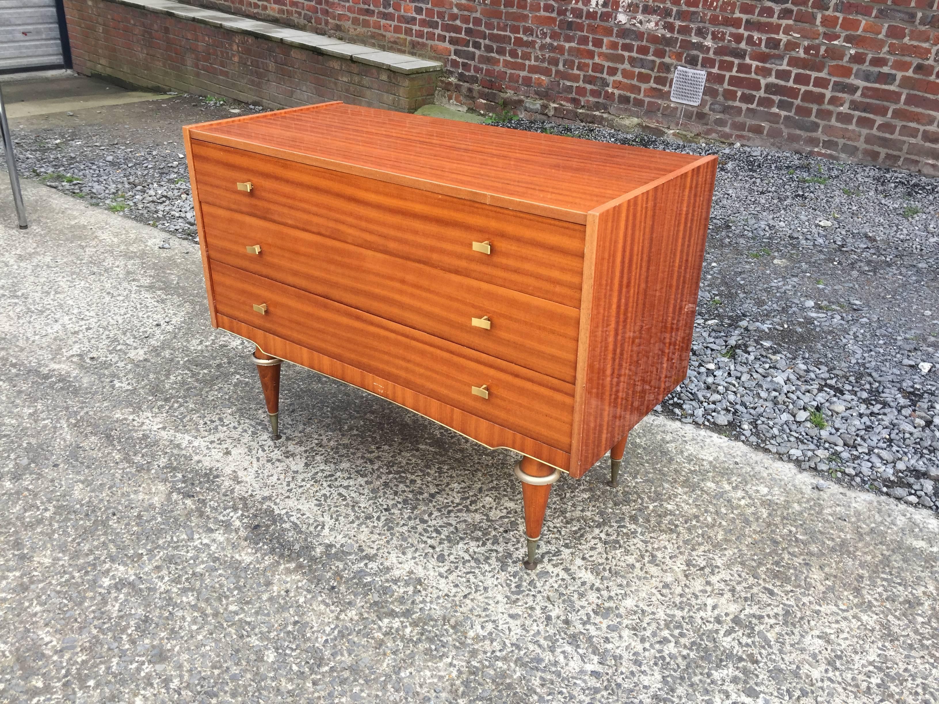Mahogany and brass chest of drawers, circa 1960.