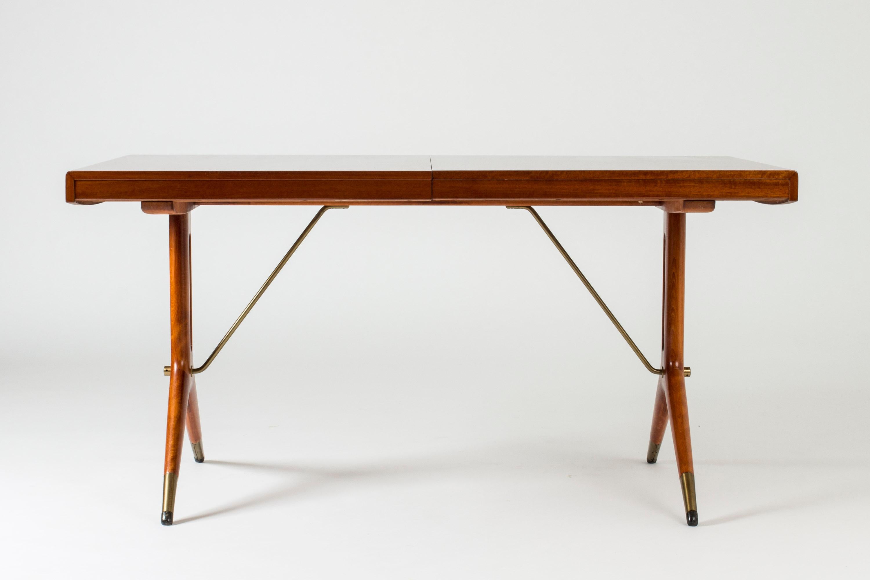 Beautiful “Napoli” dining table by David Rosén. Mahogany tabletop and elegantly sculpted legs with brass details. Two extra leaves make this a versatile table that looks great in all lengths.

The length of the table without extensions is 147 cm,