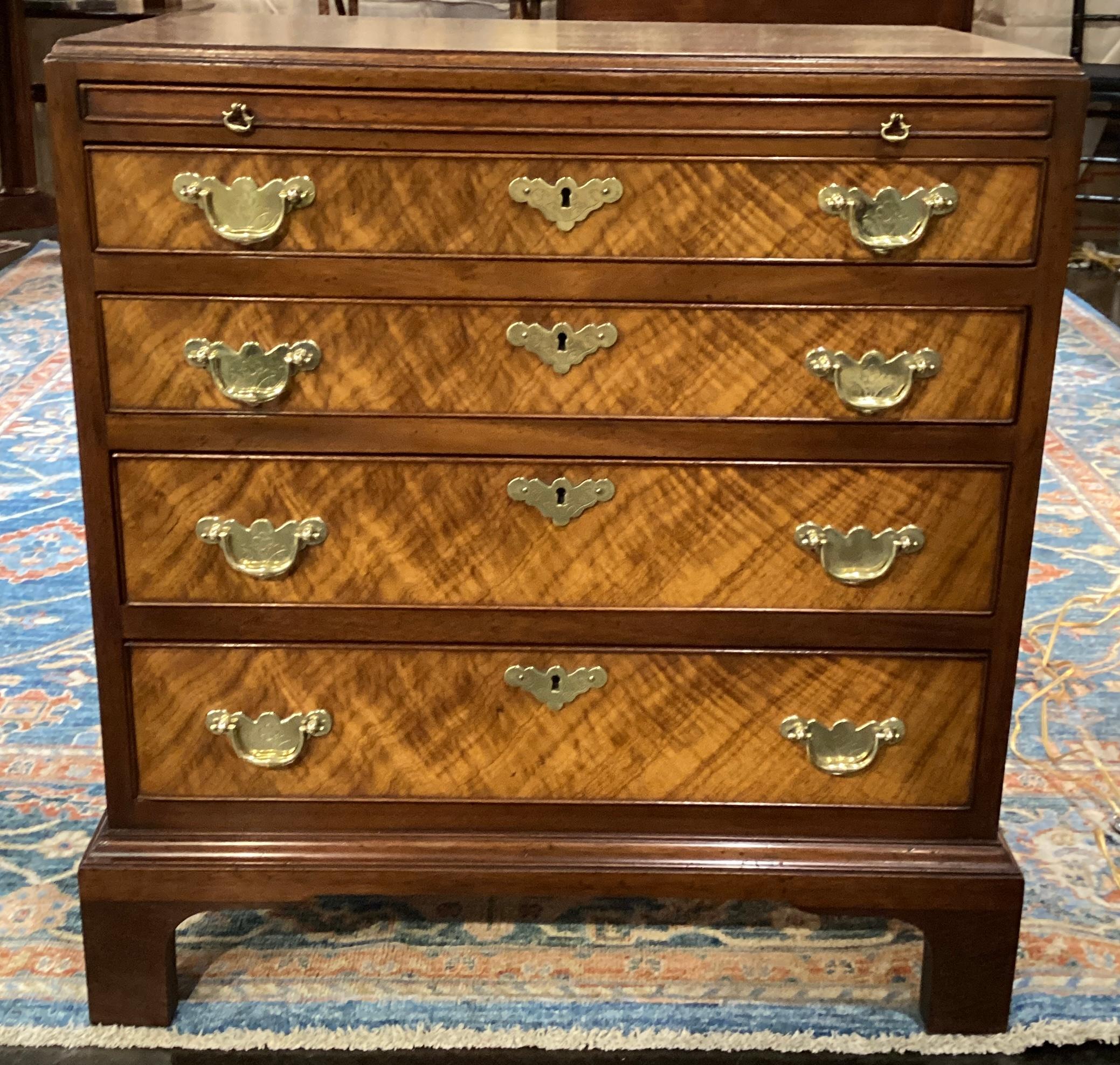 A charming Mahogany and Burled wood bachelors chest by Beacon Hill furniture company. Desirable compact size makes it useful as a bedside chest or in a living room space. Mahogany construction beautifully accented with striking burled wood.Four