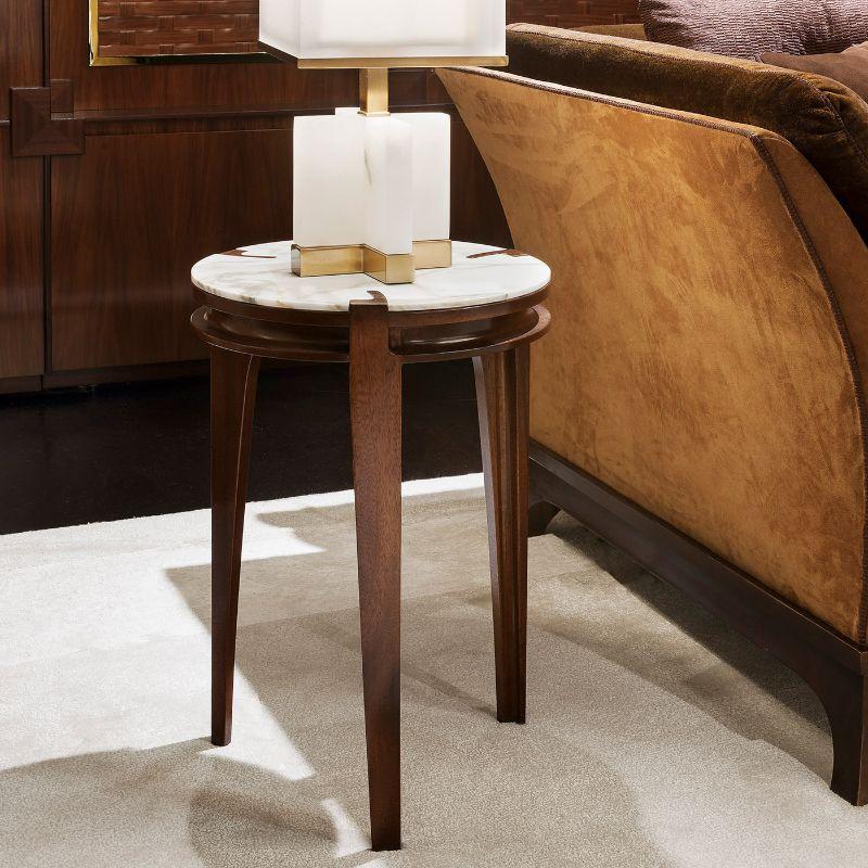 A deft showcase of craftsmanship that follows traditional methods with minute attention to detail, this precious side table combines mahogany wood with Calacatta marble in a clean yet striking three-leg design. Available in other woods and marbles.