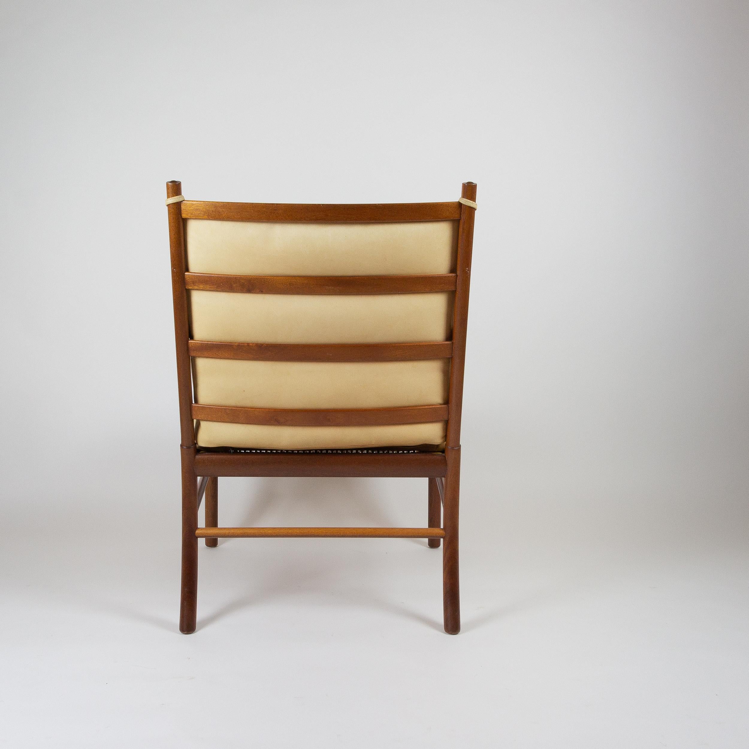An Ole Wanscher Colonial armchair in a rare combination of mahogany and original tan leather. Designed in 1949 and produced by Poul Jeppesen. This chair is in excellent vintage condition and has clearly seen little use over the years. The leather is