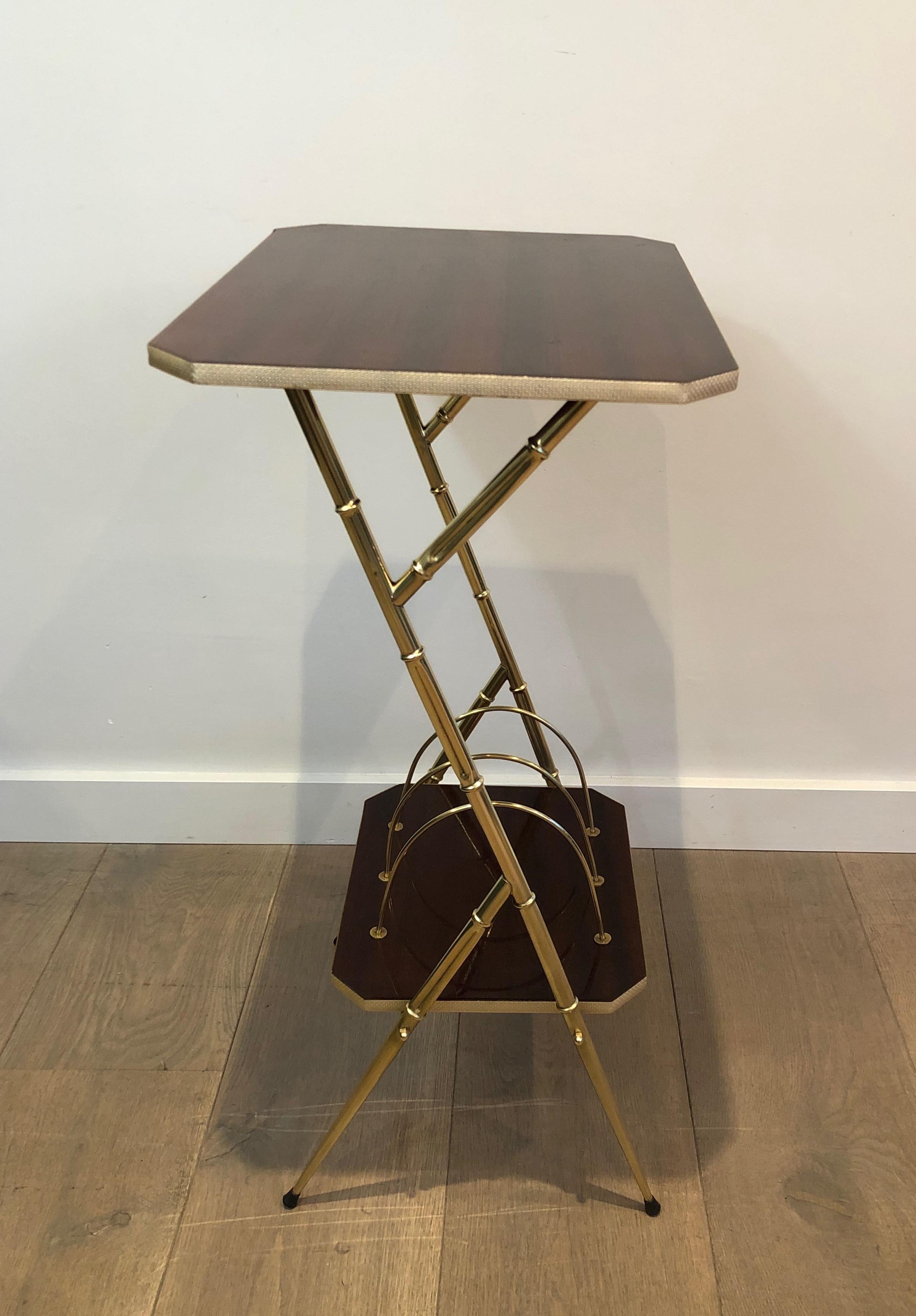 This magazine rack side table is made of mahogany and faux-bamboo gilt metal. This is a French work, circa 1970.