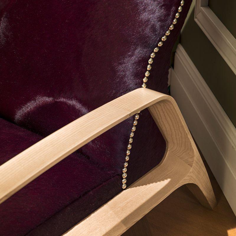 A sumptuous and refined armchair of extraordinary visual impact, this splendid piece combines clean and linear lines with a precious jacquard fabric upholstery. Fashioned of mahogany, the rounded and sleek base structure is also available in ashwood.
