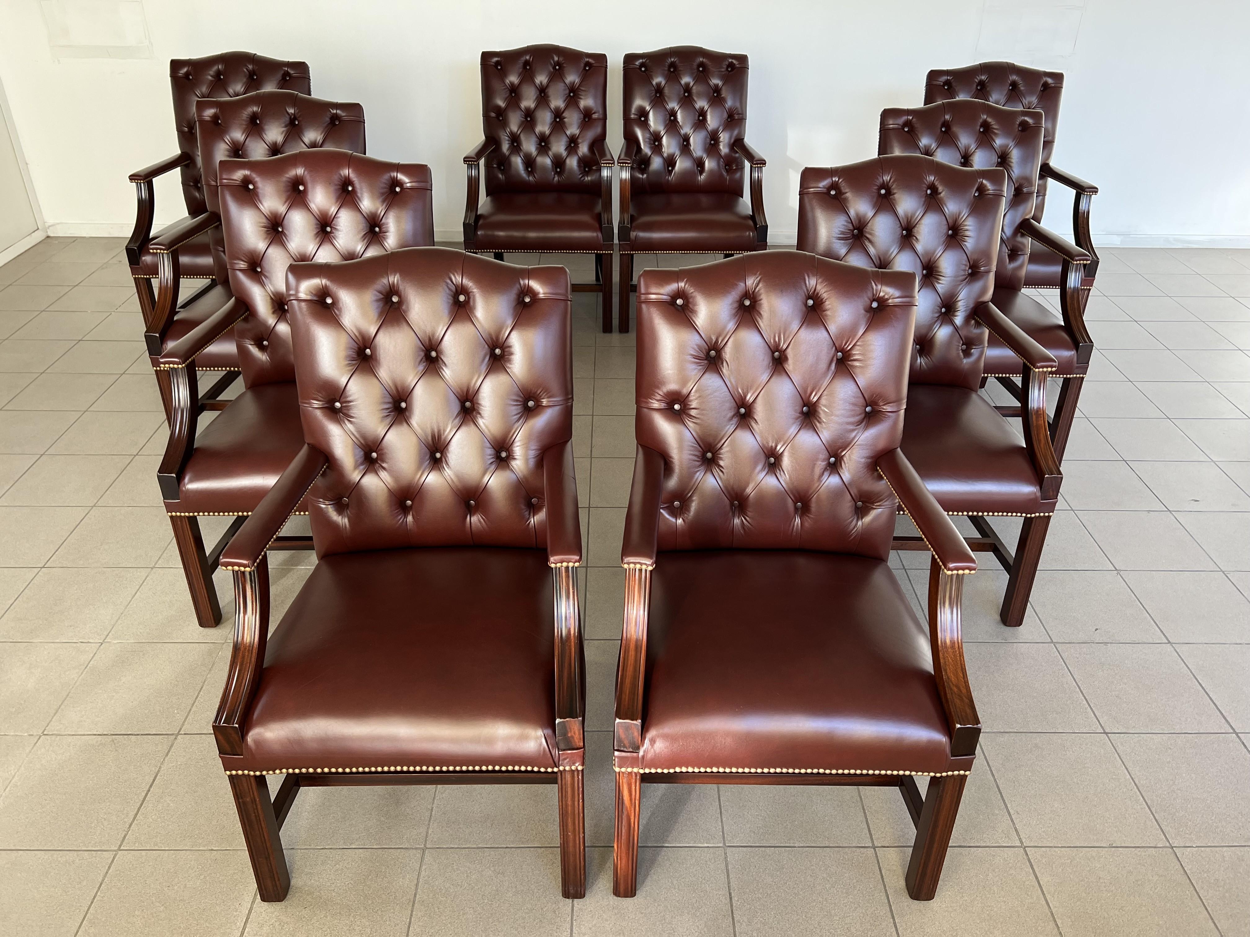 An impressive button back Gainsborough Chesterfield brown leather mahogany framed hall armchairs or dining chairs - Set of 10. Heavy and solid, these are an incredibly high quality pieces with nail-head trim individually placed by hand. Rare set of