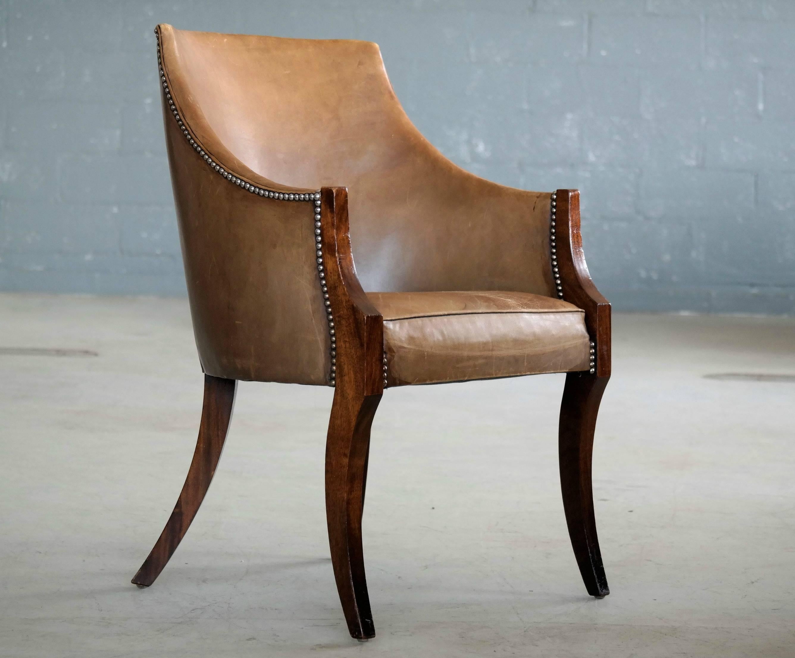 Elegant side chair by Master Furniture Maker, Frits Henningsen likely made in the 1930s. Crafted in fine cuts of Cuban mahogany with gracefully curved legs and fitted light brown leather upholstery. Appropriate age wear to the wood with some scuffs
