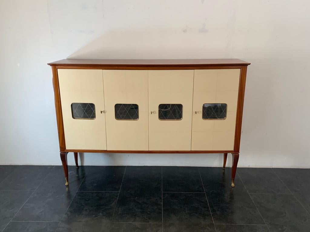 Elegant Salon Furniture in mahogany and finished in parchment on the doors and drawers inside, the legs moved and carved end on feline-shaped bronze tips. On the doors and inside the center mirrored glass decorated with diamonds. Slight wear on the