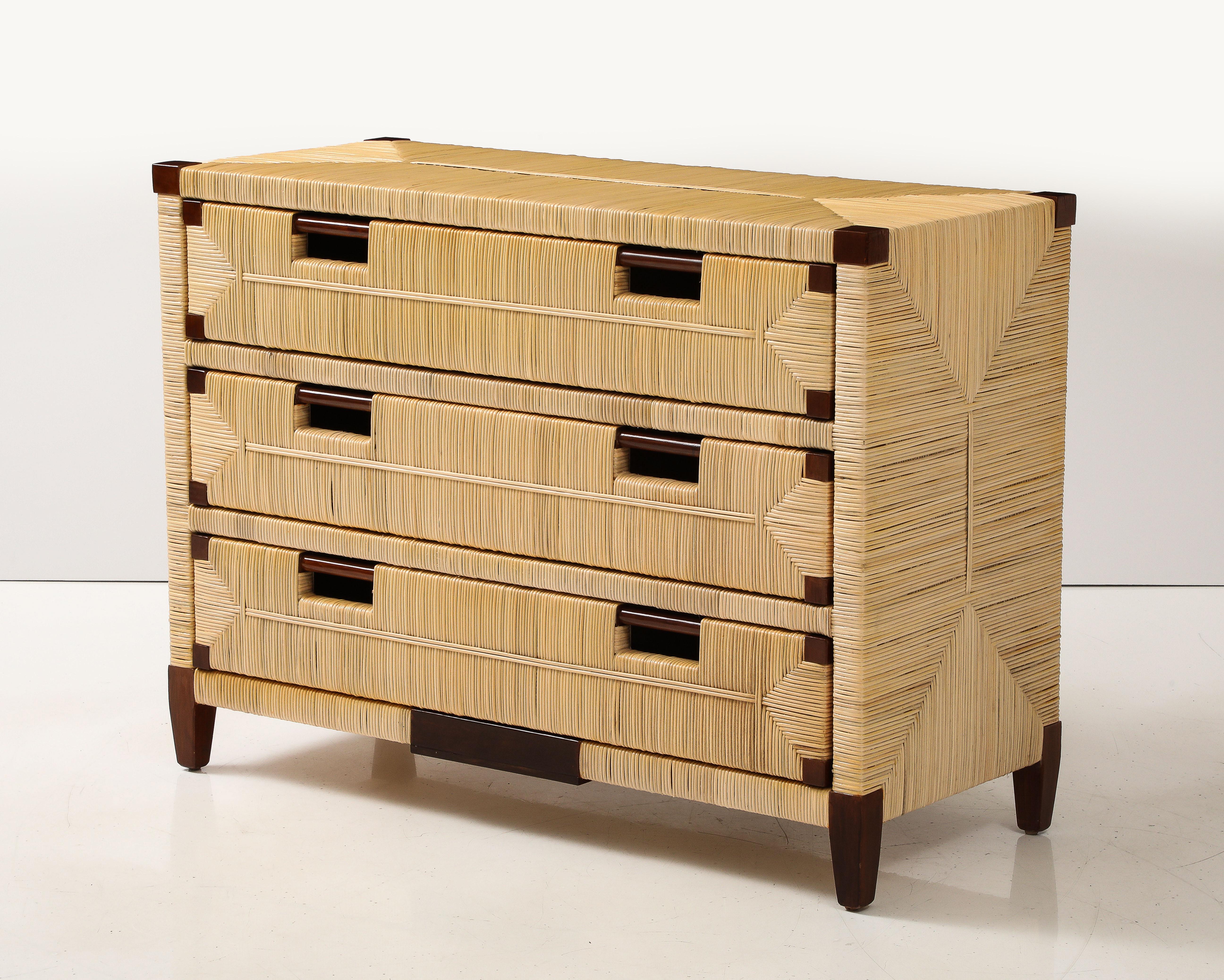 Rare commode from the limited production Merbau collection designed by John Hutton (1947-2006) for Donghia, circa 1995. Constructed of solid mahogany and covered in “rush