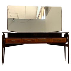 Console with Mirror from the 1950s in mahogany and rosewood with brass tips. Console with Mirror from the 1950s in mahogany and rosewood with brass tips.