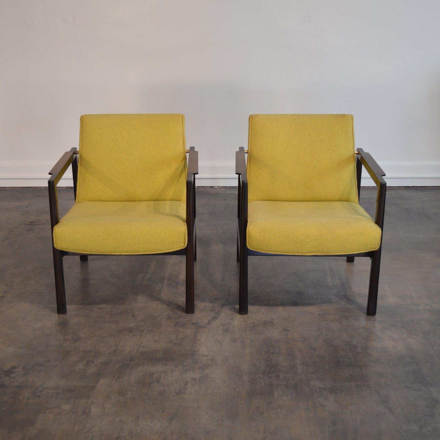 A pair of open frame lounge chairs by Edward Wormley for Dunbar, in dark espresso lacquered mahogany, with brass accents, rosewood armrests, and original chartreuse wool upholstery.

In contrast to the frame's box, nearly every component is subtly