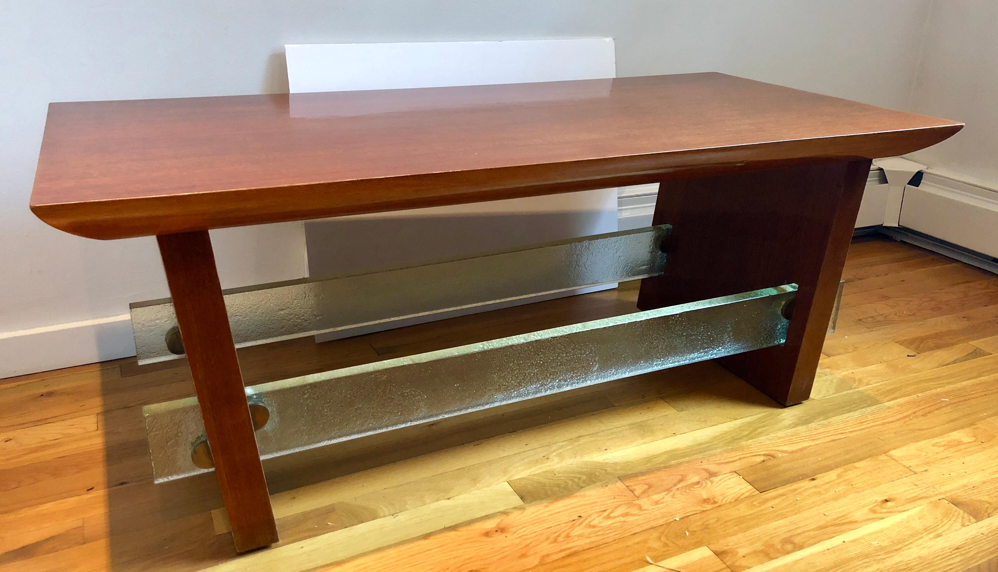 Interesting circa 1940s French modernist design employing the high/low mix strongly associated with the designs of Jacques Adnet in this period. Chunky, almost rustic slab mahogany veneered top and slightly angled trestle legs, joined by 1” thick