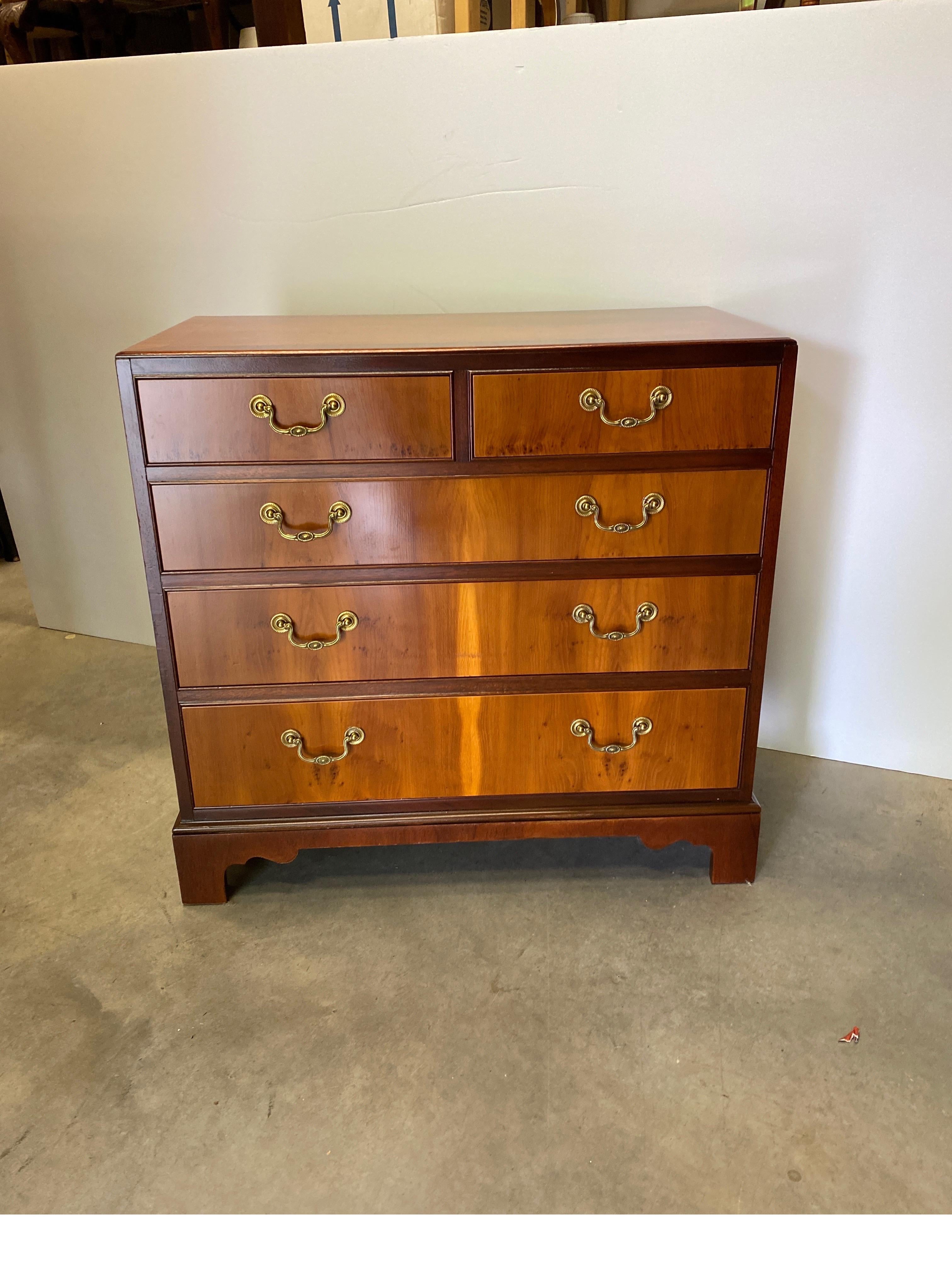 Elegant mahogany and Yew Wood bachelors chest by Baker Furniture. The mahogany top and sides with cross banding decoration. The drawer fronts with yew wood which contrasts beautifully with the mahogany. Marked Baker Furniture on the inside top